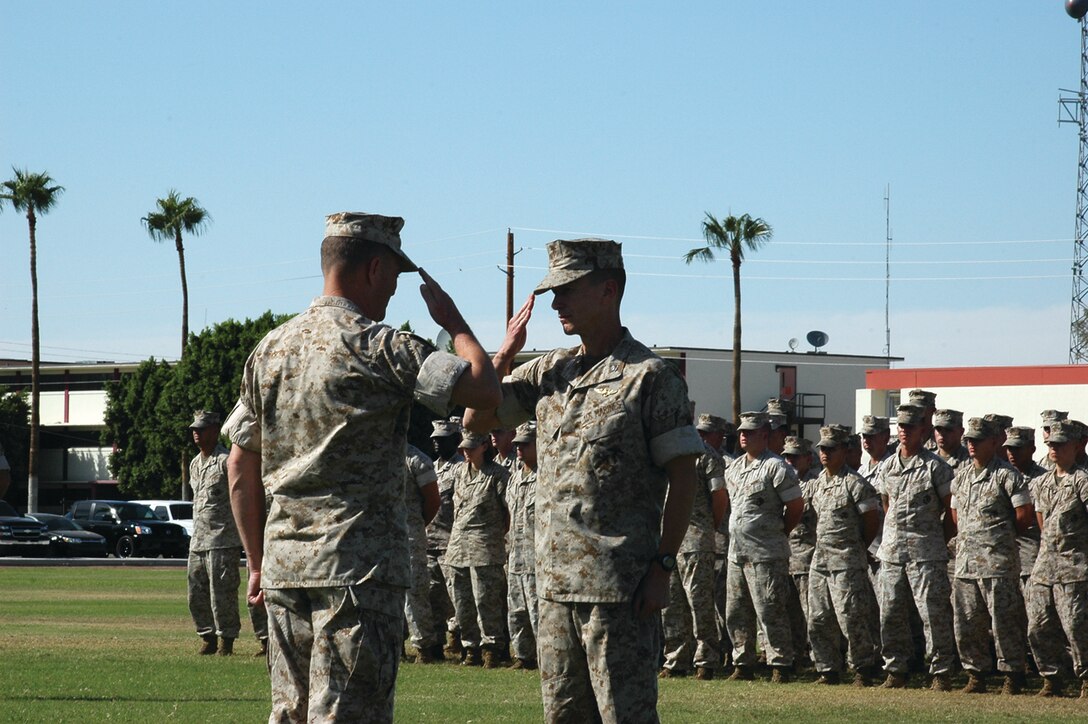 Col. Ben Hancock, station commanding officer, salutes Maj. Gen. Michael Lehnert, Marine Corps Installations West commanding general, during an award formation on the station parade deck Tuesday. The station received a Meritorious Unit Commendation for outstanding work performed from October 2004 to September 2005.
