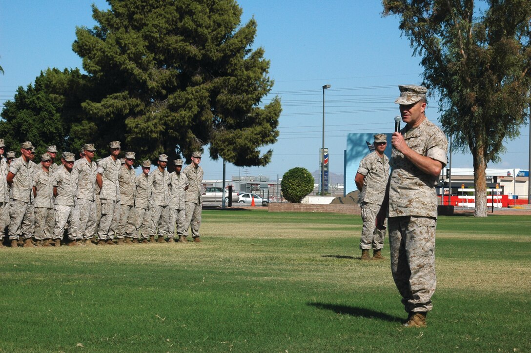 Maj. Gen. Michael Lehnert, Marine Corps Installations West commanding general, praises the hard work of listening Headquarters and Headquarters Squadron Marines after awarding them a Meritorious Unit Commendation Tuesday on the station parade deck.