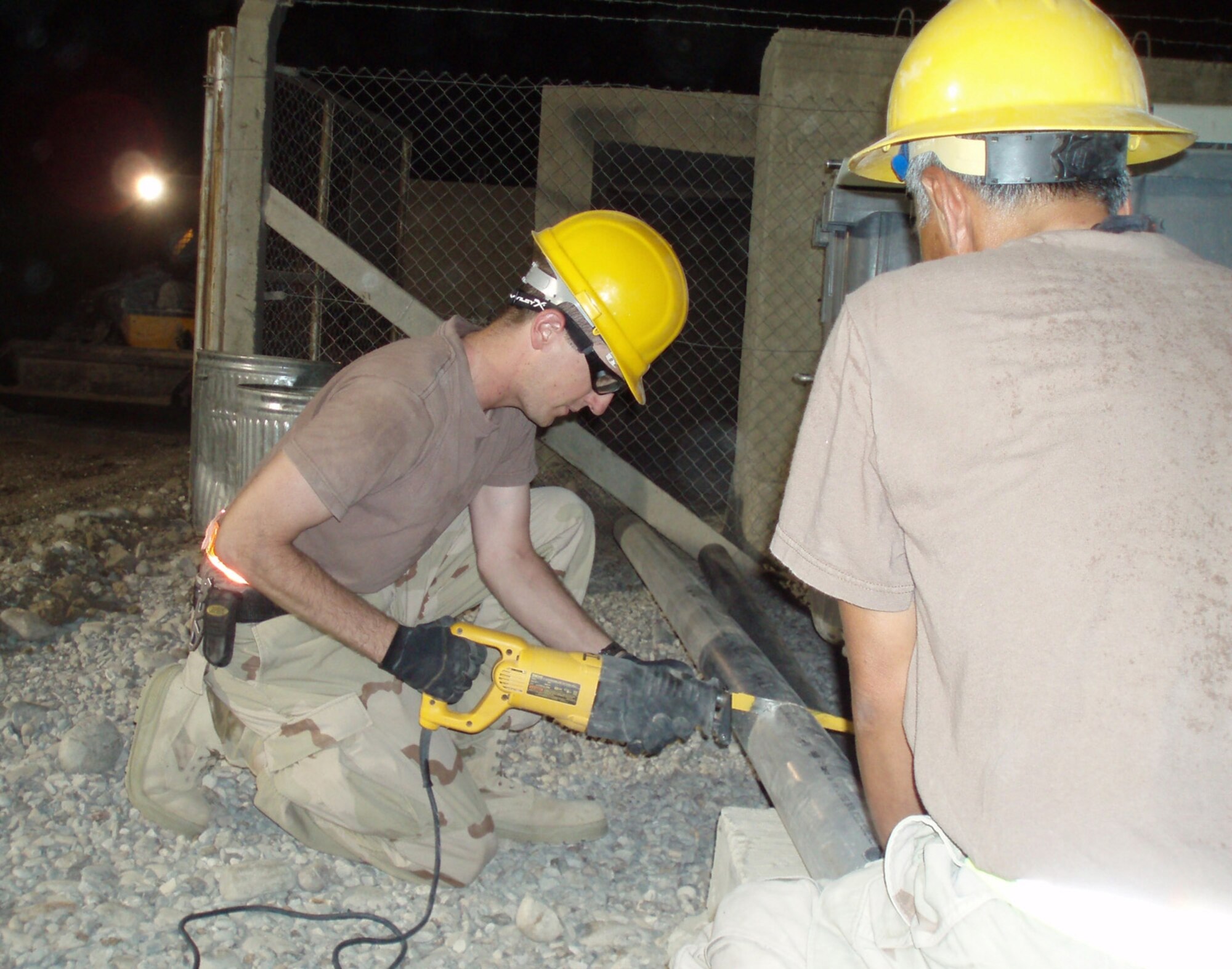 BAGHDAD, Iraq—First Lt. James Emge, a communications engineer with the 52nd Combat Communications Squadron, works with an Iraqi engineering and installation team during a recent deployment. (Air Force photo by Sue Sapp)