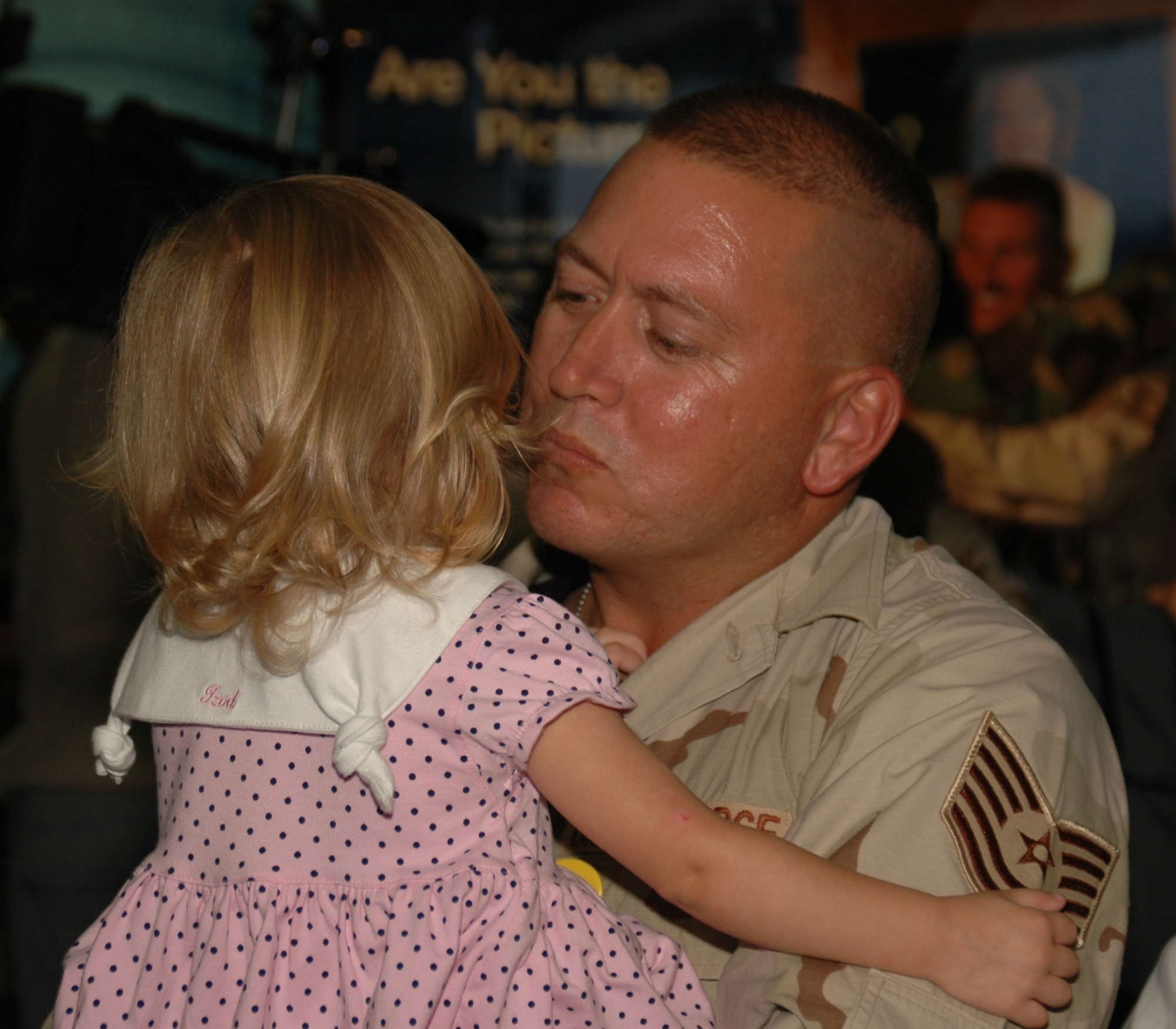 A reservist with the 315th Civil Engineer Squadron, Charleston AFB, S.C., hugs his daughter upon returning from a four-month deployment in Southwest Asia. (Photo by Master Sgt. Thomas Crawford USAFR)