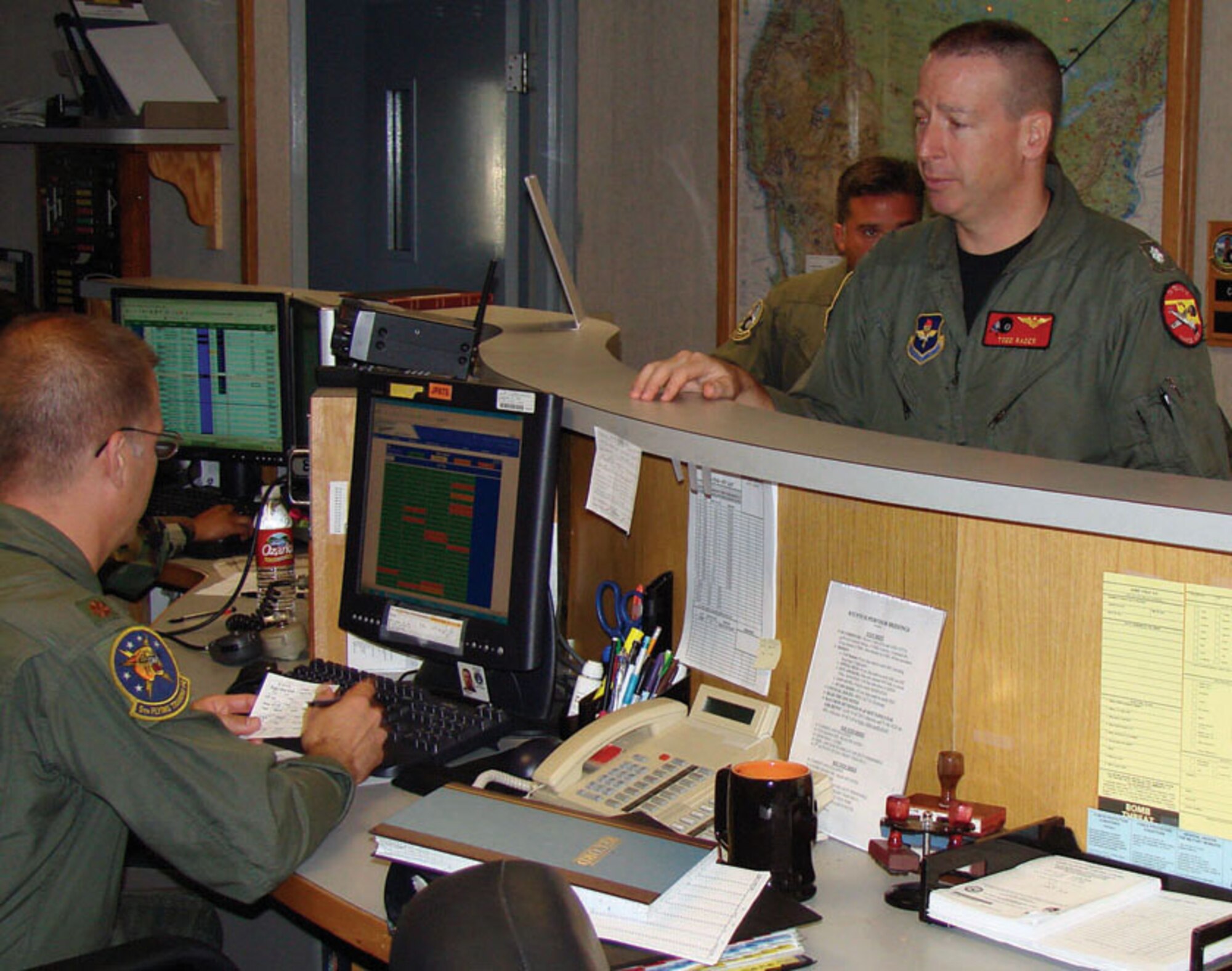 Navy Cmdr. Todd Rader checks in at the Vance Air Force Base, Okla., operations desk Oct. 4 prior to departing on a training sortie.  Commander Rader, the 8th Flying Training Squadron commander, currently is the only active-duty naval officer serving as an Air Force squadron commander in the Air Education and Training Command.  He carries on a tradition of having a Navy officer rotate every other year as commanding officer of the unit.  (U.S. Air Force photo/Capt. Tony Wickman)