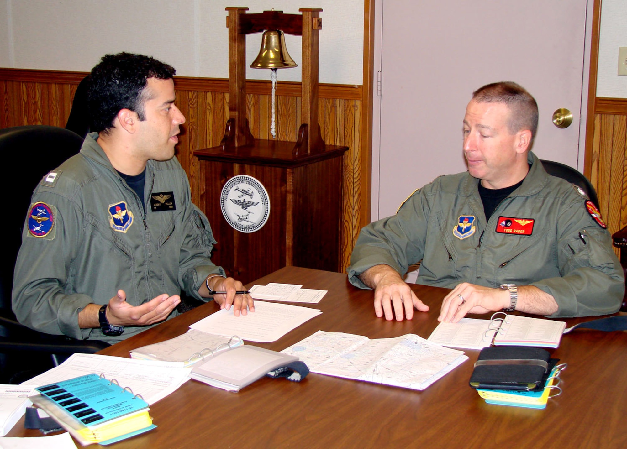Navy Lt. Jeremy Vellon (left) briefs Navy Cmdr. Todd Rader Oct. 4 on mission details for their morning T-6 Texan II sortie.  Commander Rader is the 8th Flying Training Squadron commander at Vance Air Force Base, Okla.  He took command of the 8th FTS in June and carries on a tradition of having a Navy officer rotate every other year as commanding officer of the unit.  Lieutenant Vellon is an 8th FTS instructor pilot.  (U.S. Air Force photo/Capt. Tony Wickman)