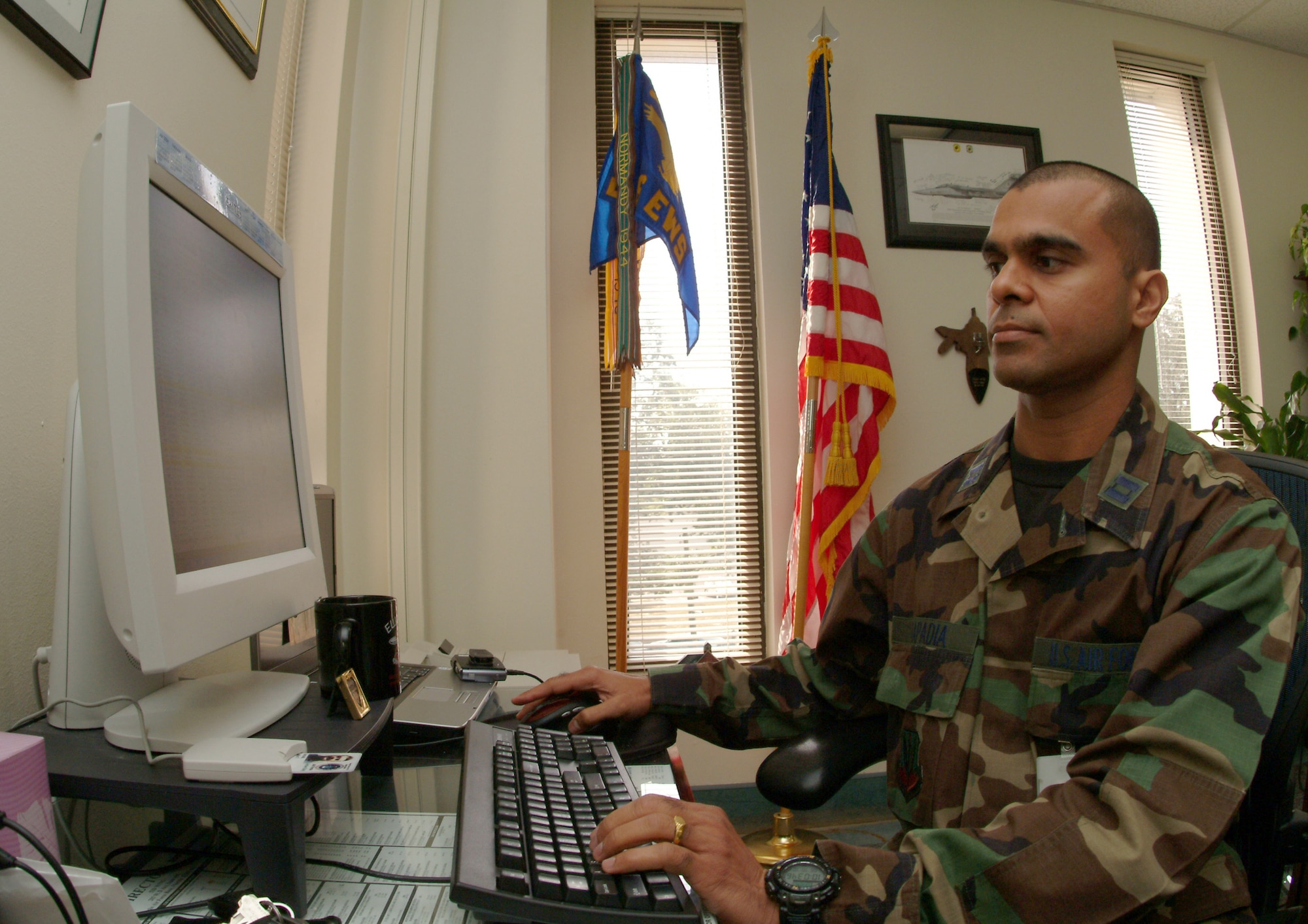 Capt. Ashok Kapadia, 36th Electronic Warfare Squadron, works on a spreadsheet for the B-2 testing program.  Captain Kapadia immigrated to the United States in 1990 from India.  After becoming a citizen, he enlisted in the Air Force, got a bachelor's degree in engineering and became an officer.  (U.S. Air Force photo by Staff Sgt. Samuel King Jr.)