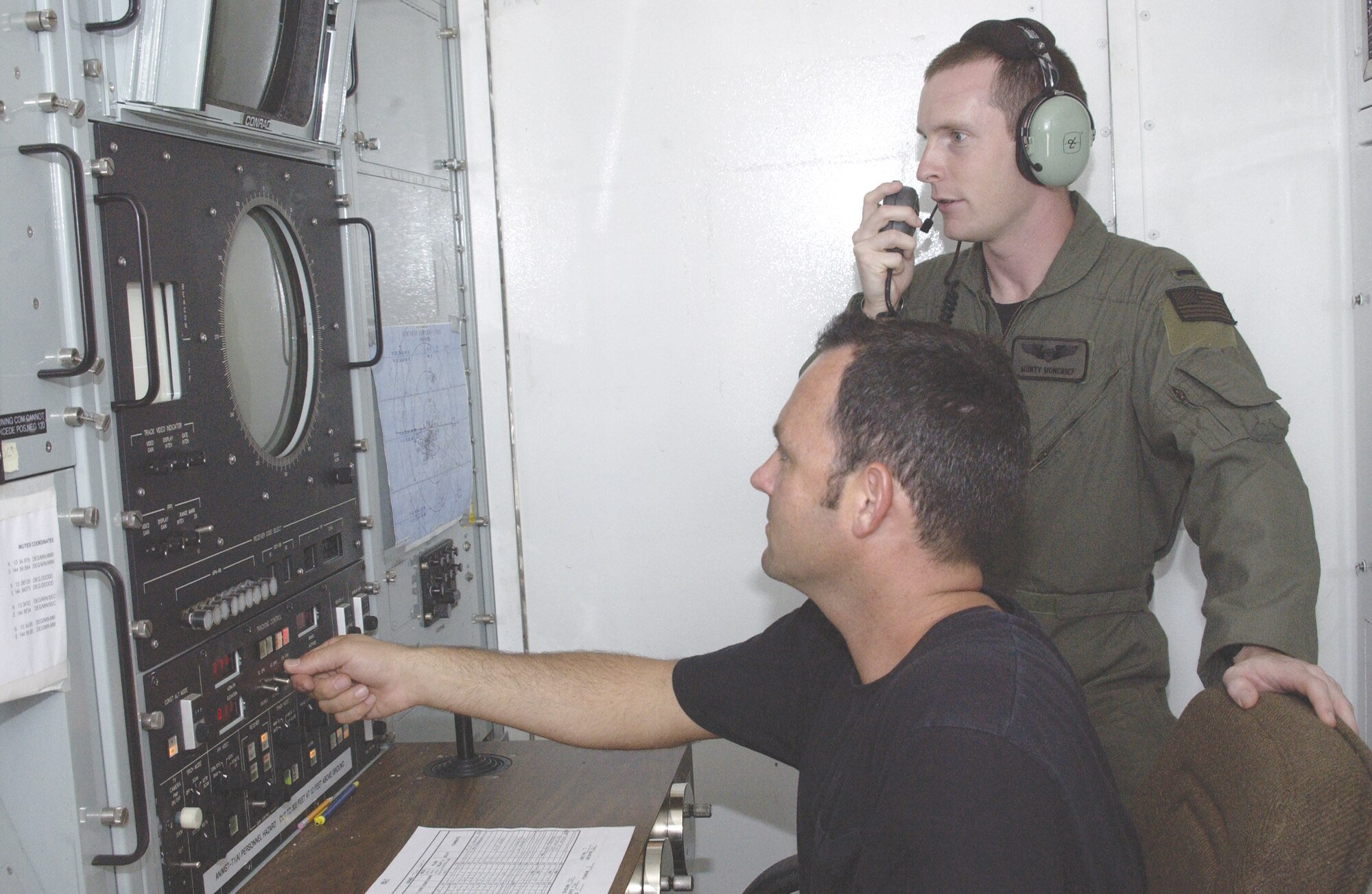 Tech Sgt. Donald Taylor (front), 266th Range Squadron ground radar technician, coordinates simulated threat signals with 1st Lt. Monty Moncrief, 23rd Expeditionary Bomb Squadron electronic warfare officer. The Multiple Threat Emitter System shapes radio wave pulses to look like signals radiated by aircraft threats, such as surface-to-air missiles. (U.S. Air Force photo/Staff Sgt. Eric Petosky)