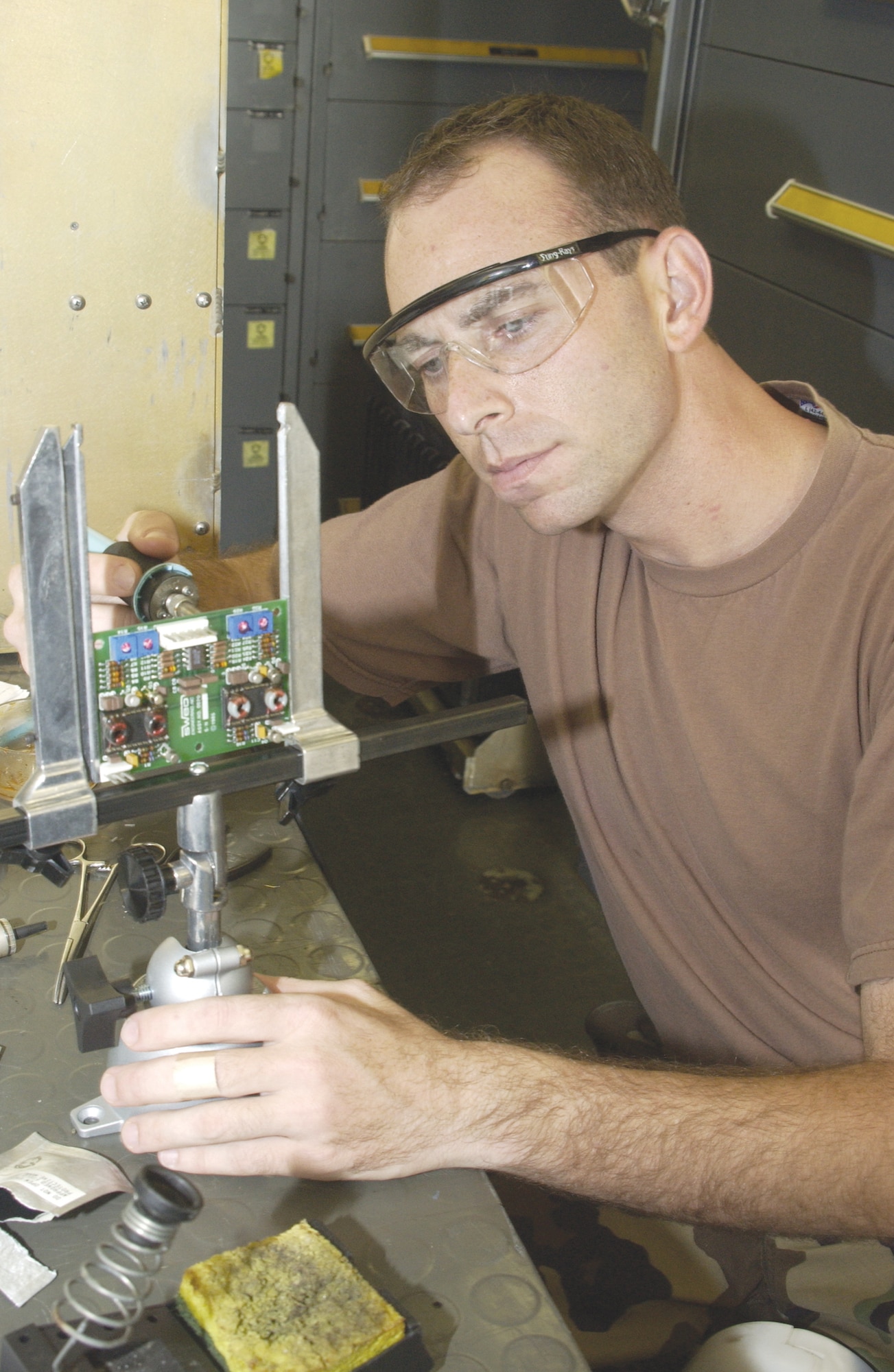 Staff Sgt. Scott Campbell, 266th Range Squadron ground radar technician, solders a transistor on a circuit card for the Multiple Threat Emitter System at Andersen Air Force Base, Guam. The MUTES offers B-52 electronic warfare officers of the 23rd Expeditionary Bomb Squadron training opportunities to quickly identify simulated threats to their aircraft, such as surface-to-air missiles. Sergeant Campbell is deployed from Mountain Home Air Force Base, Idaho. (U.S. Air Force photo/Staff Sgt. Eric Petosky)
