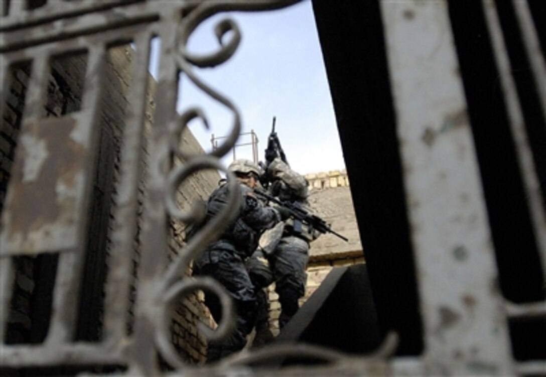 U.S. Army soldiers from Company A, 1st Battalion, 23rd Infantry Regiment, 2nd Brigade Combat Team, 1st Armored Division, Multi-National Division – Baghdad, clear a building during Operation Half Nelson in Baghdad, Oct. 4, 2006.