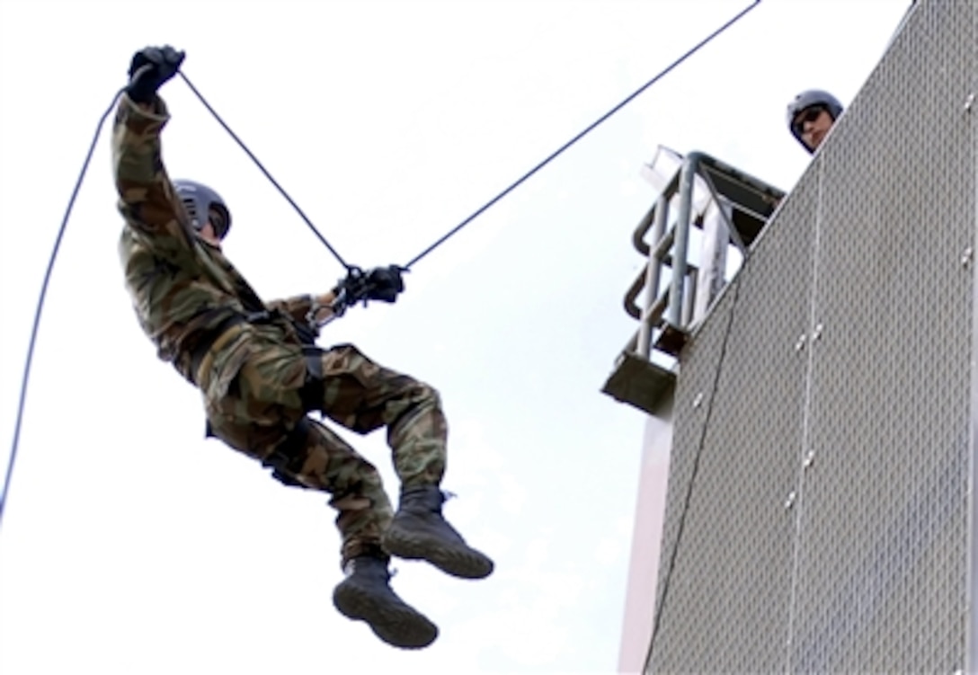 Petty Officer 2nd Class Ryan Waller, assigned to Explosive Ordnance Disposal Mobile Unit 8, descends from the rappelling tower during training aboard Naval Air Station Sigonella, Sigonella, Sicily, Oct. 5, 2006. 