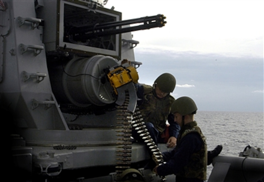 U.S. Navy fire controlmen load .20-caliber tungsten ammunition into a weapons system onboard the USS Wasp, Oct. 5, 2006, during a deployment in the Mediterranean Sea. 