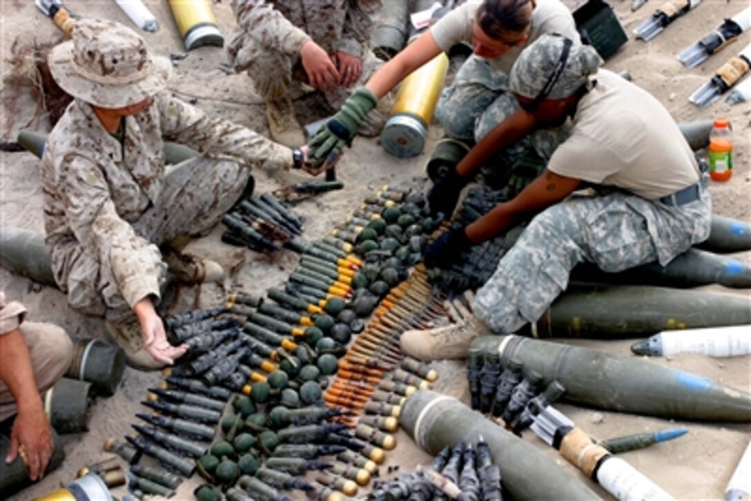 U.S. Marines from the ammunition detachment, Combat Logistics Regiment 15, 1st Marine Logistics Group (Forward) prepare ordnance for detonation as part of emergency destruction training, Oct. 4, 2006, in the Al Anbar province of Iraq.  