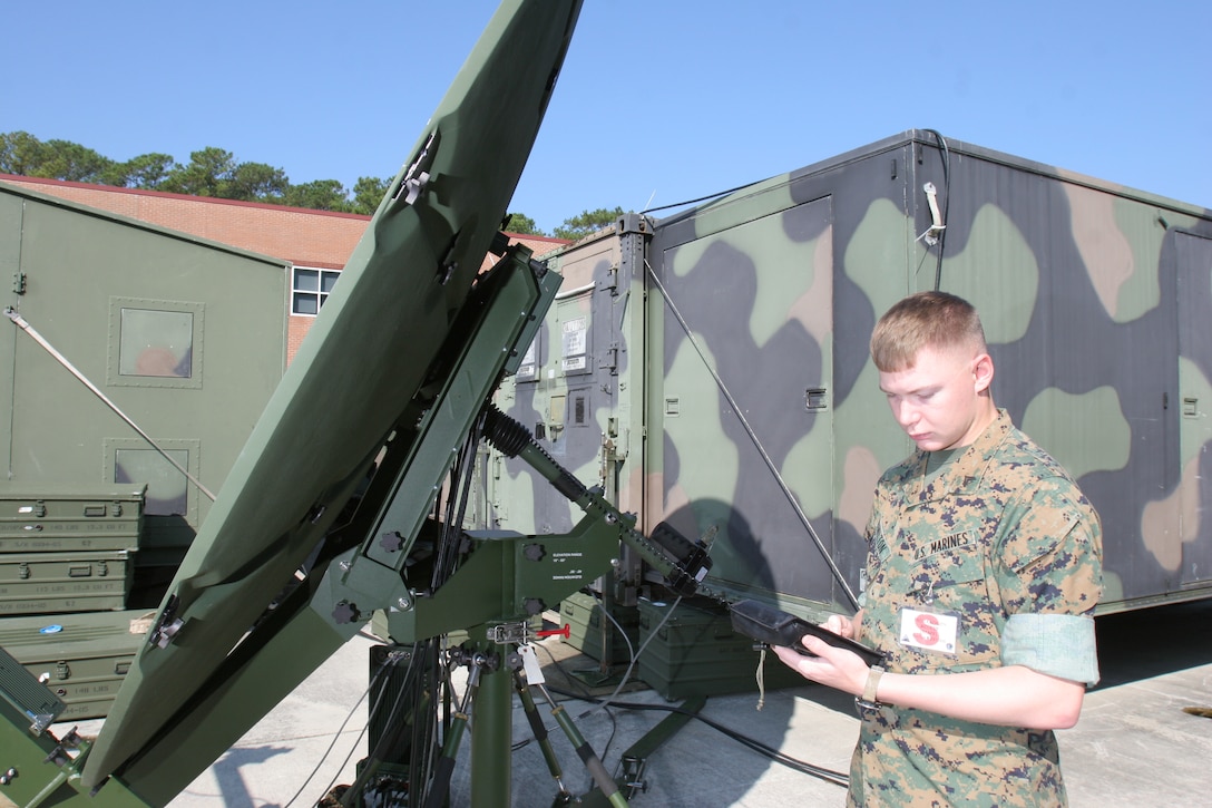 Cpl. Cory W. Hamilton inspects the look-angle and configuration of the Trojan Lite satellite, Oct. 12, during the Mission Rehearsal Exercise here. Hamilton is a systems chief with the 2nd Marine Aircraft Wing?s 6th Special Security Communications Team.