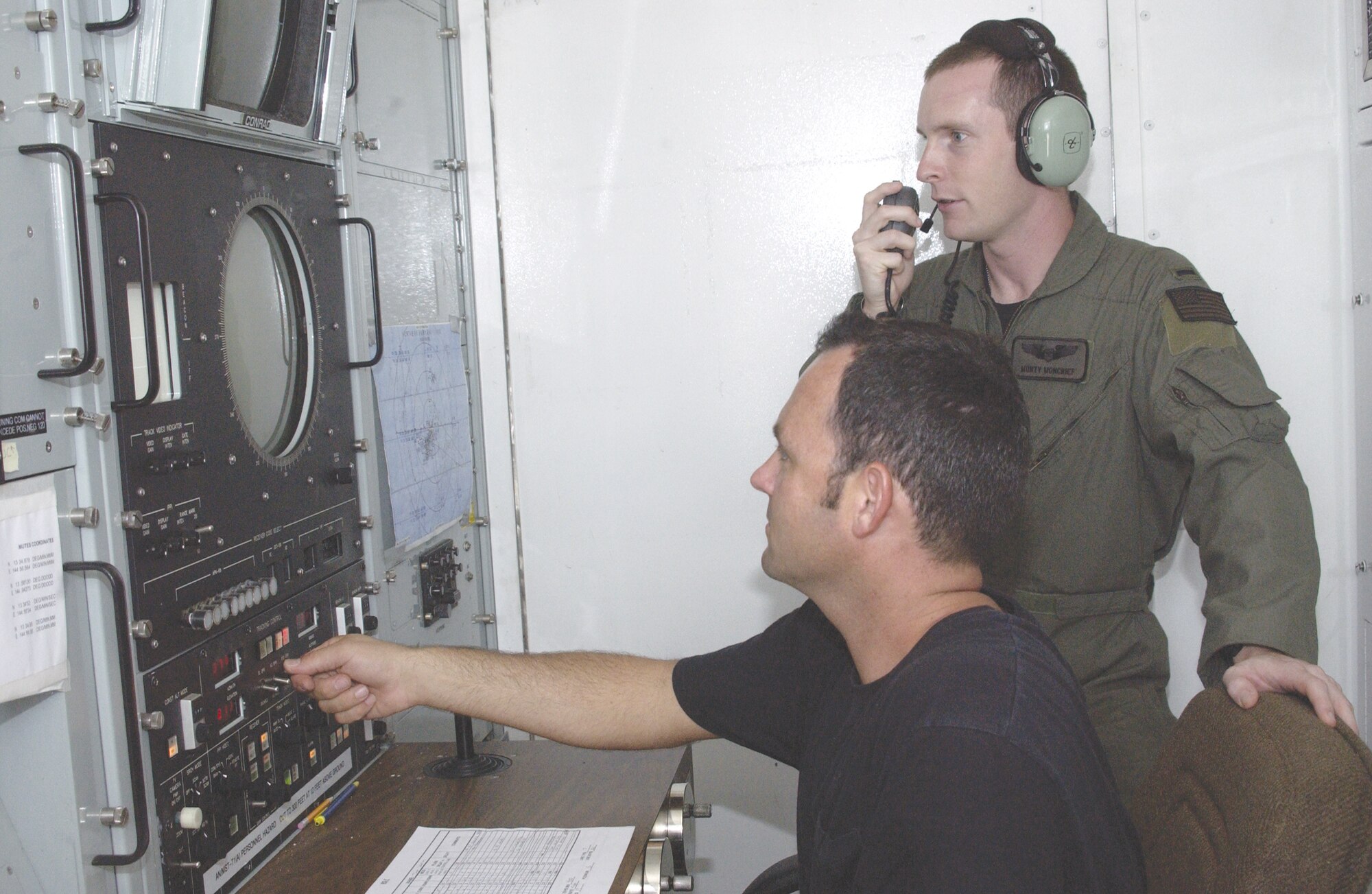 Tech Sgt. Donald Taylor (seated), 266th Range Squadron ground radar technician, coordinates simulated threat signals with 1st Lt. Monty Moncrief, 23rd Expeditionary Bomb Squadron electronic warfare officer. The Multiple Threat Emitter System shapes radio wave pulses to look like signals radiated by aircraft threats. Collaboration between EWO and radar technician improves training opportunities for B-52 EWOs deployed to Guam in support of the United States’ commitment to maintaining a continuous heavy bomber presence in the Pacific.  (Photo by Staff Sgt. Eric Petosky)