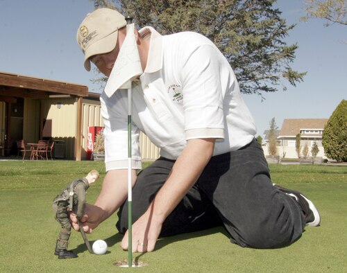 Steve Vedder Jr., 366th Services Squadron golf course golf professional, gives Viper some lessons on improving his putting game. Mr. Vedder offers half-hour lessons for $25 or five lessons for $100 at the golf course. "I will give the lessons year-round," said Mr. Vedder. "Even in the dead of winter, if you want to improve your game, I am here for you." (Photo by Senior Airman Brian Stives)

