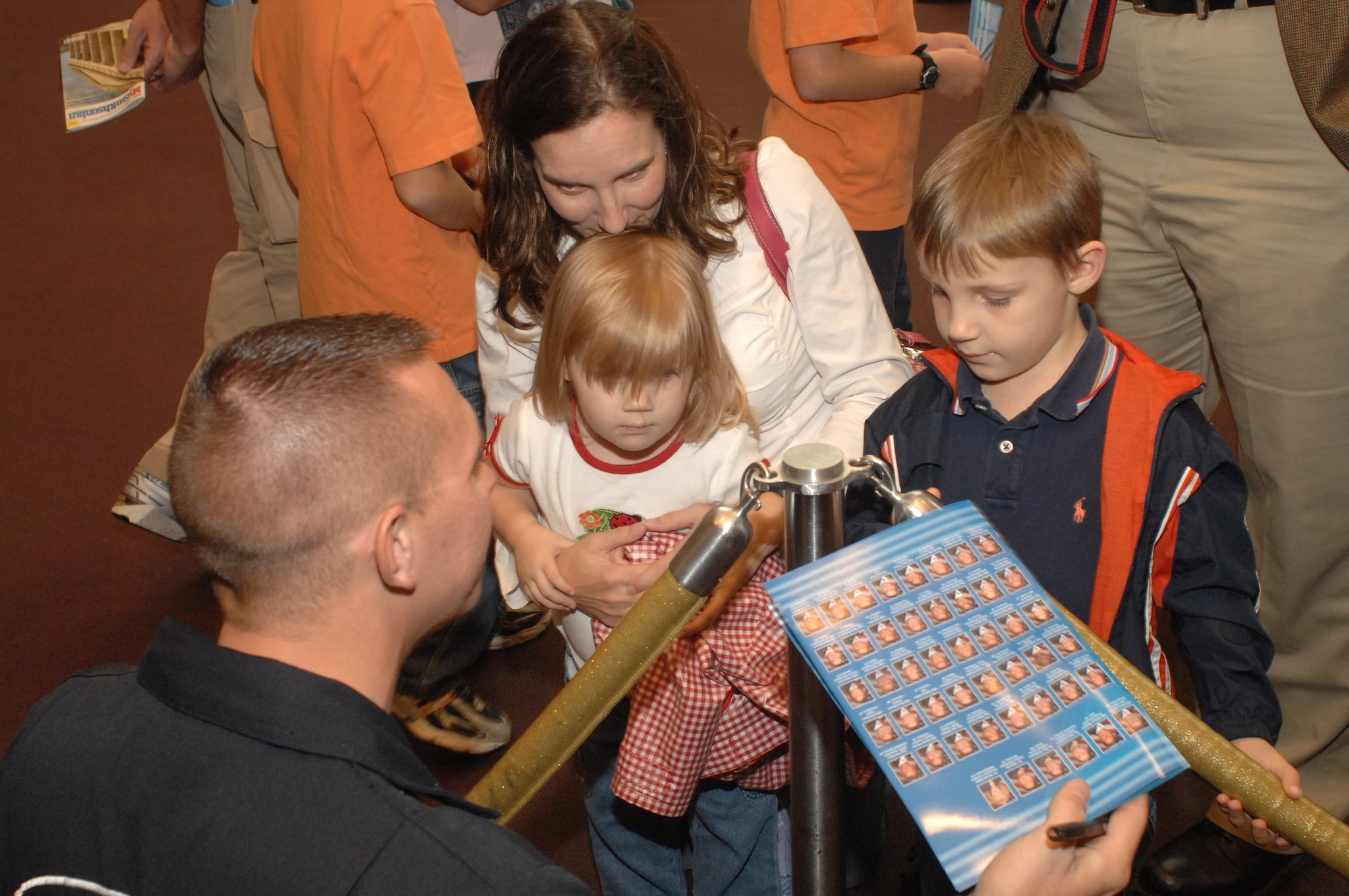 Staff Sgt. Clint Bryant sign autographs was at the Smithsonian Air and Space Museum Oct. 11 in Washington, D.C. Sergeant Bryant is a member of the Air Force Thunderbirds demonstration team and was at the Smithsonian as part of a week-long series of events that will culminate with the opening of the Air Force Memorial Oct. 14. (U.S. Air Force photo/Master Sgt. Gary R. Coppage)