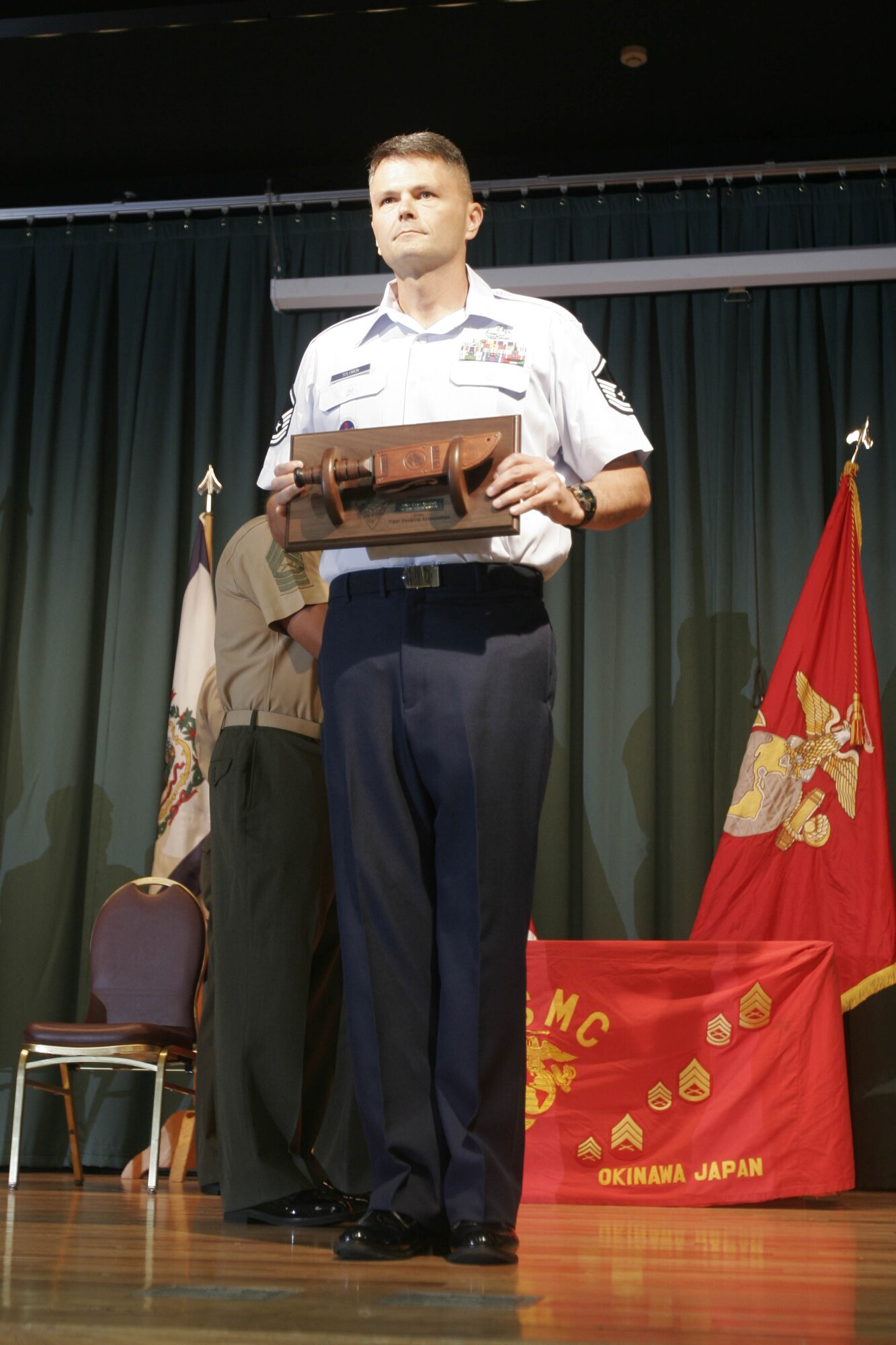 CAMP HANSEN, OKINAWA, Japan — Air Force Master Sgt. Gary Solomon receives the ‘Gung Ho’ Award during the Staff Noncommissioned Officer Academy Advanced Course 6-06 graduation Sept. 26 at The Palms on Camp Hansen. Solomon is the first non-Marine to win an award at the Okinawa SNCOA. Solomon is a munitions systems specialist with 372 Training Squadron, Air Education Training Command on Kadena Air Base. (Official U.S. Marine Corps photo by Lance Cpl. Bryan A. Peterson) 