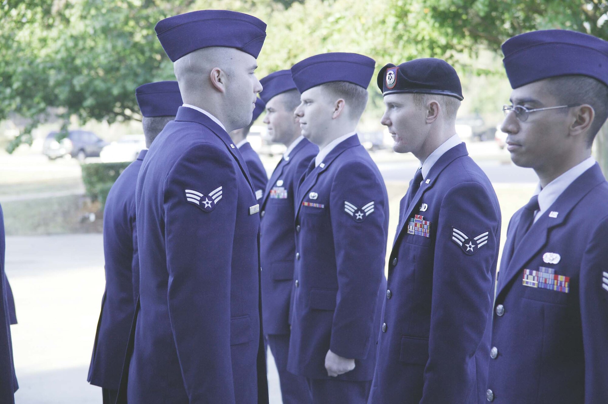 Senior Airman Jonathan Lott, Airman Leadership School student, assists in a uniform inspection of his classmates Thursday. (U.S. Air Force photo/Senior Airman Holly MacDonald)