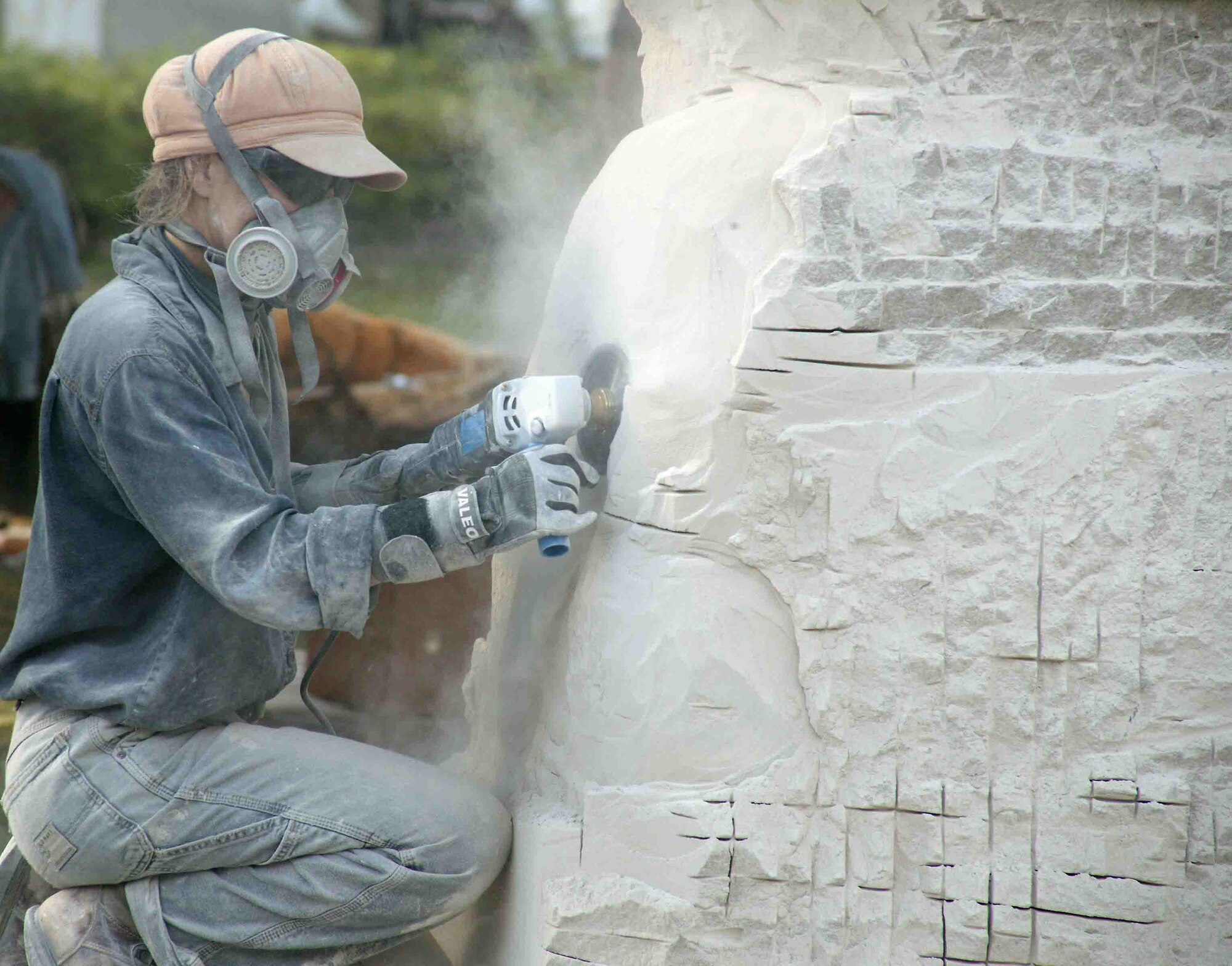 SHAW AIR FORCE BASE, S.C.-- Nora Valdez from Argentina grinds into rock to create a sculpture Tuesday outside the cultural center. She and seven other artists from around the world are taking part in the Sumter International Sculpture Symposium. The event continues through Thursday. (U.S. Air Force photo/Tarsha Storey)