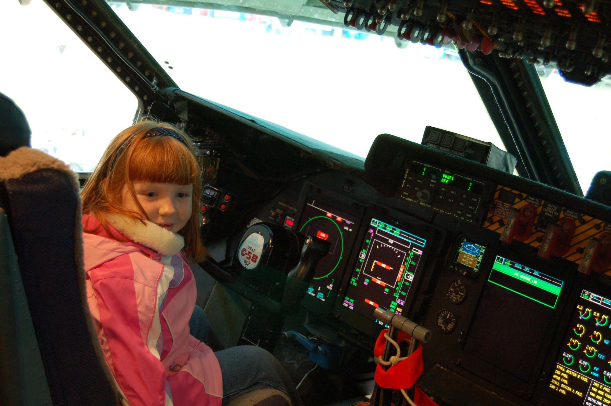Elizabeth Kukulich, daughter of Richard Kukulich of Bear, Del., sits in the cockpit of a C-5 Galaxy while touring the C-5 static display here Saturday. The static display gave Open House attendees an inside look at the C-5’s enormous cargoholds, crew compartments and flightdeck areas. (U.S. Air Force photo/Staff Sgt. James Wilkinson)