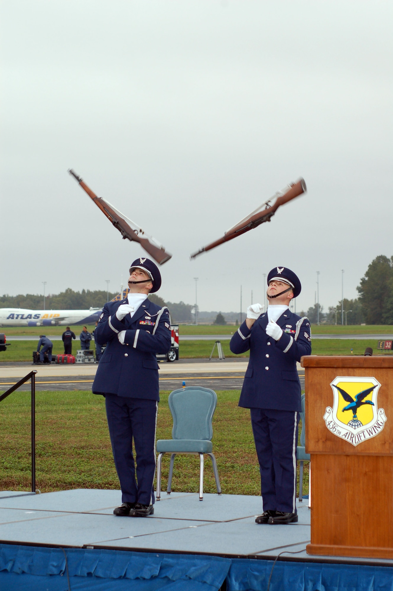 (Left to right) Senior Airmen Tony Riddle and Michael Majors, 436th Aircraft Maintenance Squadron and Dover Air Force Base Honor Guard members, spin their rifles into the air while performing a silent drill during the opening ceremony of the 2006 Dover Air Force Base Open House here Saturday. The team represents the United States Air Force in the showcase of professional drill performances at public and military venues, and serves to recruit, retain and increase awareness for the Air Force and the Air Force Honor Guard as the official “Ambassadors in Blue.” (U.S. Air Force photo/Staff Sgt. James Wilkinson)
