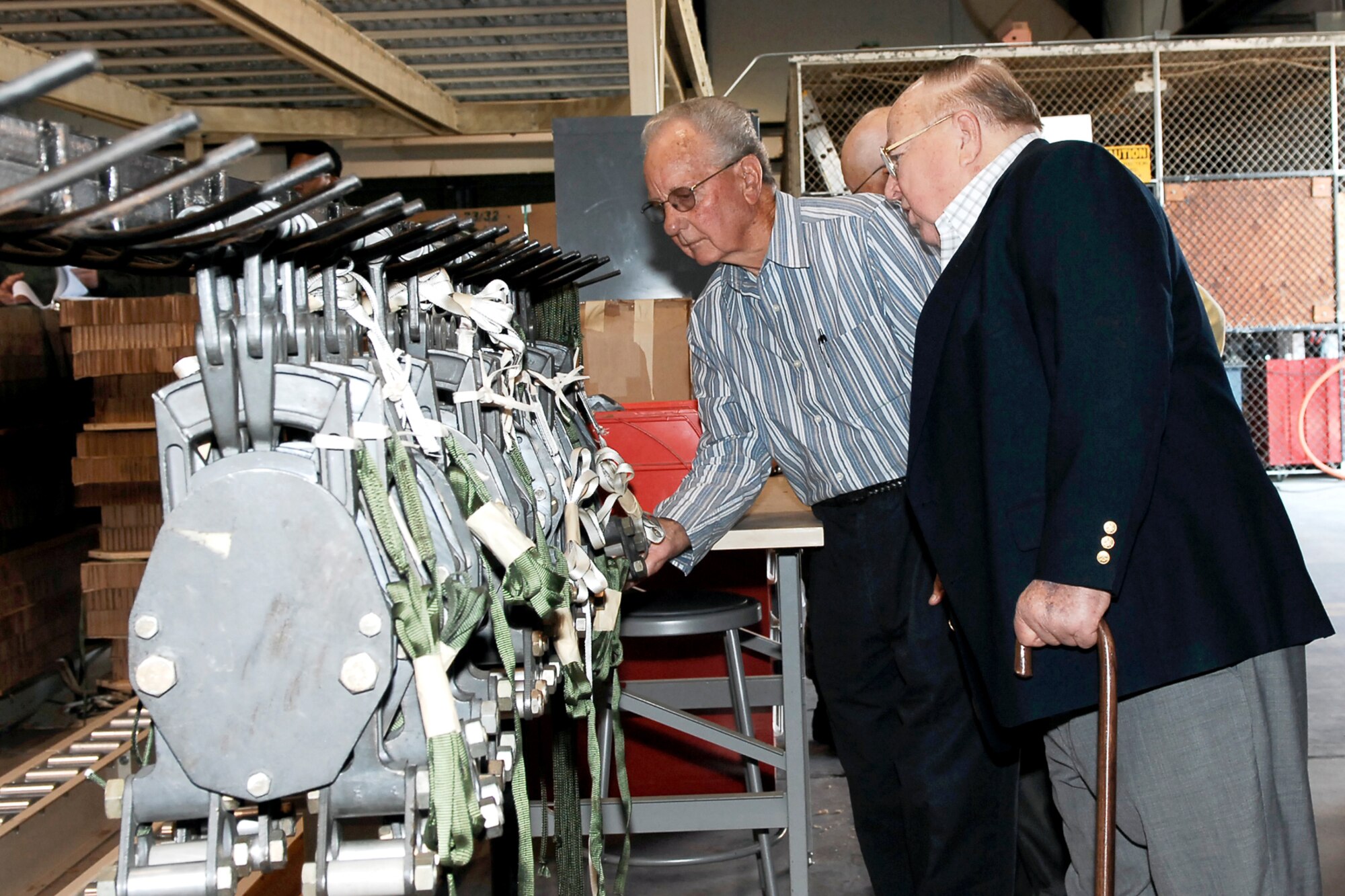 Veteran members of the 18th Aerial Port Squadron visited the 3rd Aerial Port Squadron Oct. 5 for a tour of the Air Force's latest technology and machines in the aerial mission. Here, veterans see how Airmen now load C-17 Globemaster IIIs, the C-5 Galaxy and C-130 Hercules with rollerized floors using k-loaders. In the 1950s and 1960s, they loaded aircraft by hand. (U.S. Air Force photo/Mike Murchison)