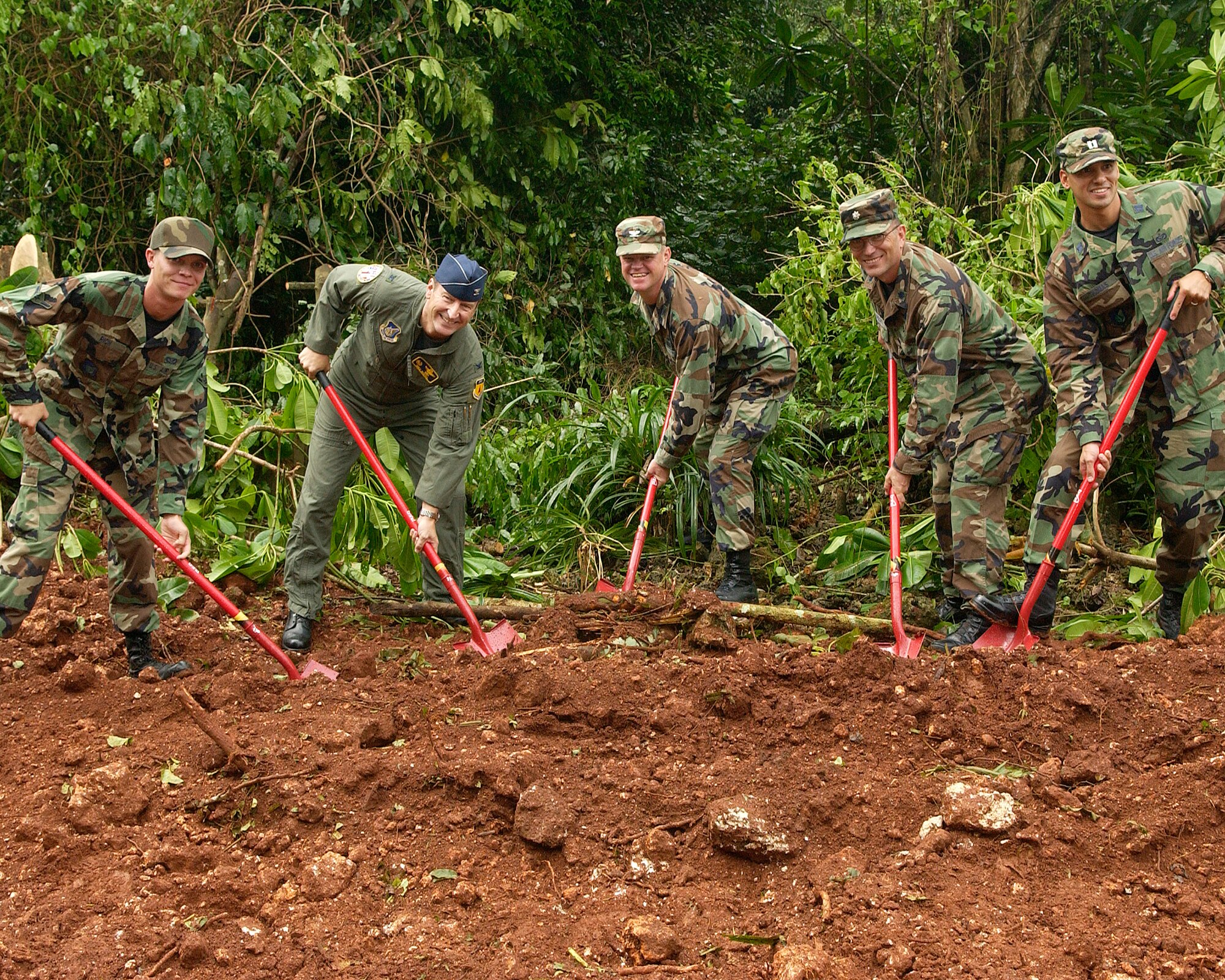 Airmen break ground at the new Northwest Field Expeditionary Combat Support Training Campus site at Andersen Air Force Base, Guam Oct. 11. The entire complex will cost approximately $240 million and will be fully operational by 2016. In addition to housing the RED HORSE, the campus will also be home to Combat Communications, Commando Warrior and Silver Flag. From left: Airman Jeremy Rich, 554th Rapid Engineer Deployable Heavy Operation Repair Squadron Engineers; Col. Michael Boera, 36th Wing commander; Col. William Corson, Pacific Air Forces director of installation and mission support; Lt. Col. Keith Albrecht, 36th Contingency Response Group vice commander; and Capt. Craig Thomas, 554th RED HORSE Squadron officer in charge. (U.S. Air Force photo/Airman 1st Class Daniel Owen)