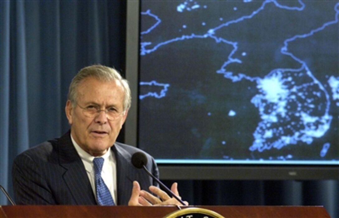 Defense Secretary Donald H. Rumsfeld addresses a reporter's question about the significance of the reported North Korean nuclear test during a Pentagon press briefing, Oct. 11, 2006.  As part of his response, he showed reporters a satellite view of the Korean peninsula taken at night.