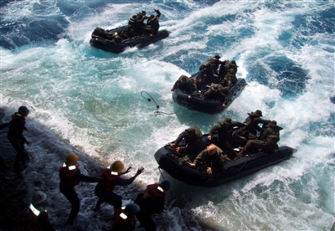 Three Combat Rubber Raiding Craft are recovered on the stern gate of amphibious transport dock ship USS Juneau after conducting operations in the Pacific Ocean, Oct. 7, 2006. 