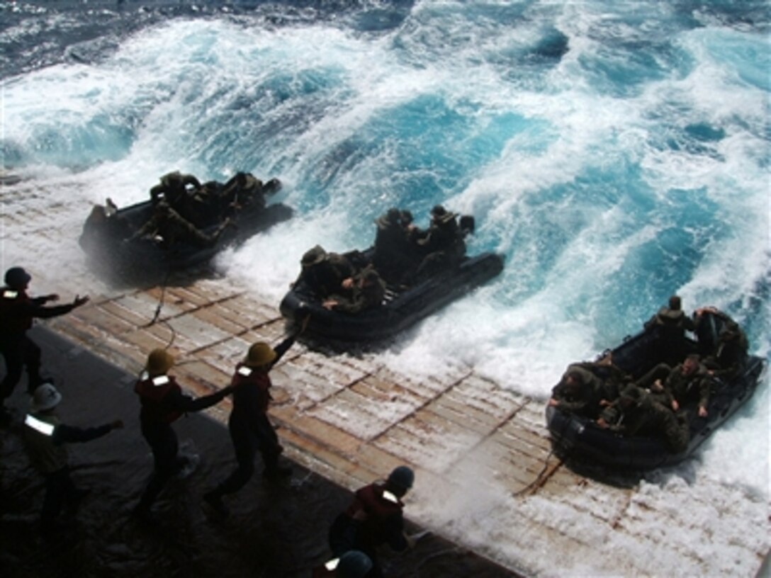 U.S. Navy sailors in combat rubber raiding craft are recovered on the stern gate of the amphibious transport dock ship USS Juneau (LPD 10) after conducting open ocean operations in the Pacific Ocean on Oct. 7, 2006.  The Juneau and the Essex Expeditionary Strike Group are conducting Blue-Green workups in preparation for a fall patrol with the 31st Marine Expeditionary Unit.  