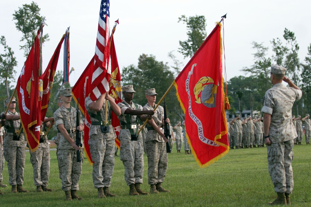 Camp Lejeune, North Carolina. September 13, 2006. Colonel Faulkner, the 2nd Marine Logistics Group forward Commanding General, salutes the colors as they are lowered, during the activation ceremony for the 2nd MLG forward.::n::(Official U.S. Marine Corps photograph by LCpl Michael J O'Brien)