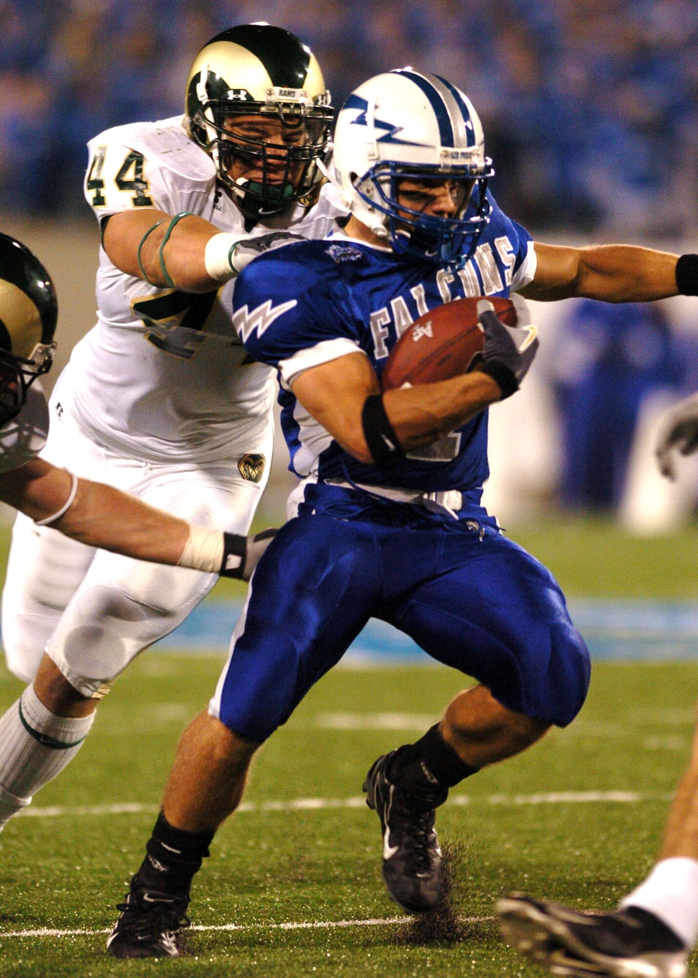 Air Force halfback Chad Hall is caught from behind Thursday night by Colorado State defensive end Bob Vomhof in the Falcon backfield and held to no gain. Hall rushed for 104 of Air Force's 322 total yards on the ground. After trailing at halftime 21-3, Air Force scored 21 unanswered points in the second half to win, 24-21. (U.S. Air Force photo/1st Lt. John Ross)
