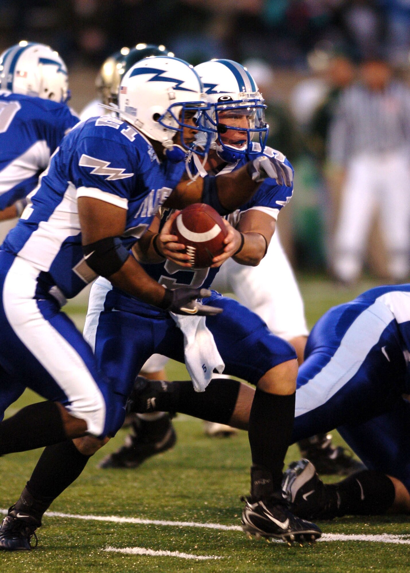 Air Force quarterback Shaun Carney hands off to fullback Ryan Williams Thursday night against cross-state rival Colorado State.  After trailing at halftime 21-3, Air Force scored 21 unanswered points in the second half to win, 24-21. (U.S. Air Force photo/1st Lt. John Ross)
