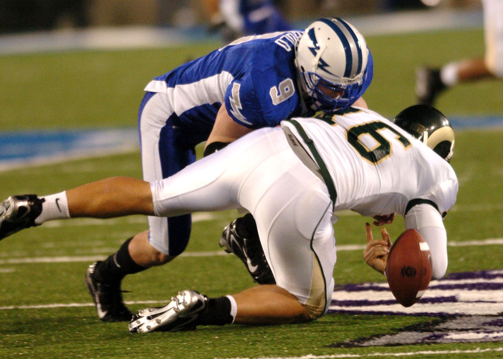 Air Force Falcon defensive back John Rabold forces Colorado State quarterback Caleb Hanie to fumble Thursday night on a third-quarter scramble. After trailing at halftime 21-3, Air Force scored 21 unanswered points in the second half to win, 24-21. (U.S. Air Force photo/1st Lt. John Ross)
