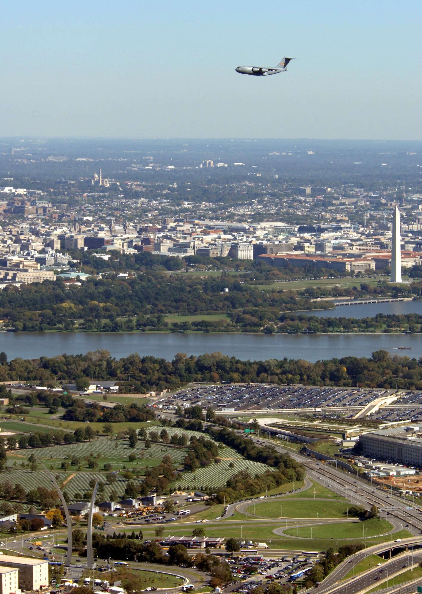 A C-17 Globemaster II flies over the Air Force Memorial during a practice flight over the Oct. 13 in Arlington, Va. The memorial dedication ceremony will be held Oct. 14. An Air Force open house will be held near the Pentagon in conjunction with the dedication ceremony that will feature performances by the U.S. Air Force Band, the U.S. Air Force Honor Guard drill team, and a concert by country music performer LeeAnn Womack. (U.S. Air Force photo by Master Sgt. Gary R. Coppage)
