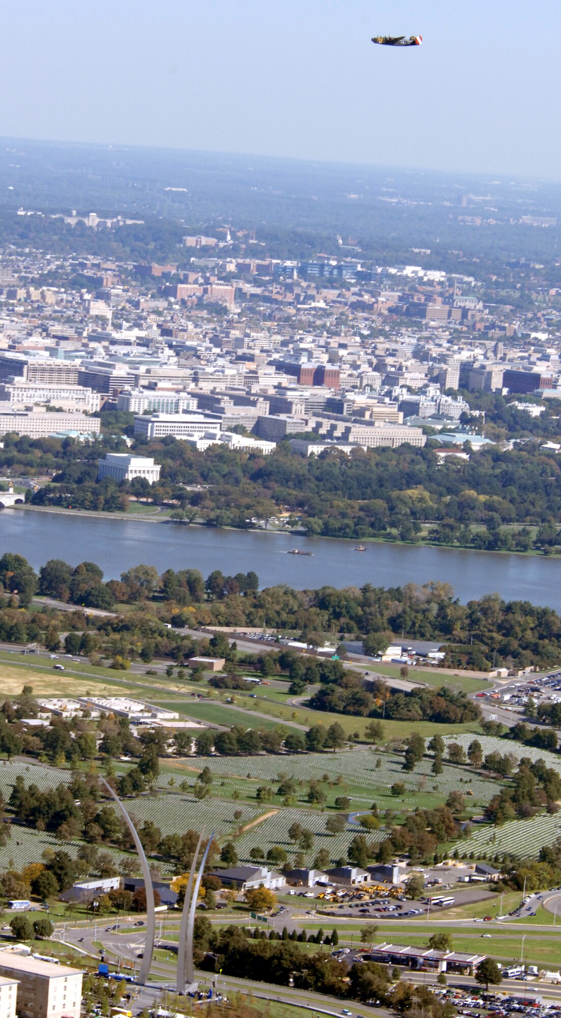 A B-24 Liberator flies over the Air Force Memorial during a practice flight over the memorial Oct. 13 in Arlington, Va. The dedication ceremony will be held Oct. 14. An Air Force open house will be held near the Pentagon in conjunction with the dedication ceremony that will feature performances by the U.S. Air Force Band, the U.S. Air Force Honor Guard drill team, and a concert by country music performer LeeAnn Womack. (U.S. Air Force photo by Master Sgt. Gary R. Coppage) 
