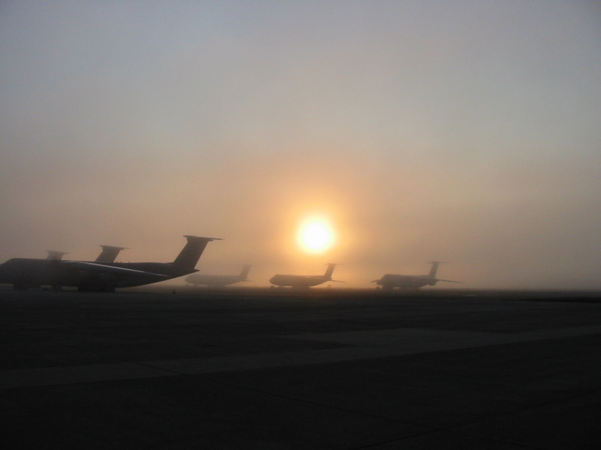 New England fog shrouds a flightline at Westover ARB, Mass., as Air Force Reserve Command C-5 Galaxy transports await their missions. Westover is the home the 439th Airlift Wing, which includes more than 2,500 reservists from 32 states. (US Air Force photo / Master Sgt. Steven Ross )