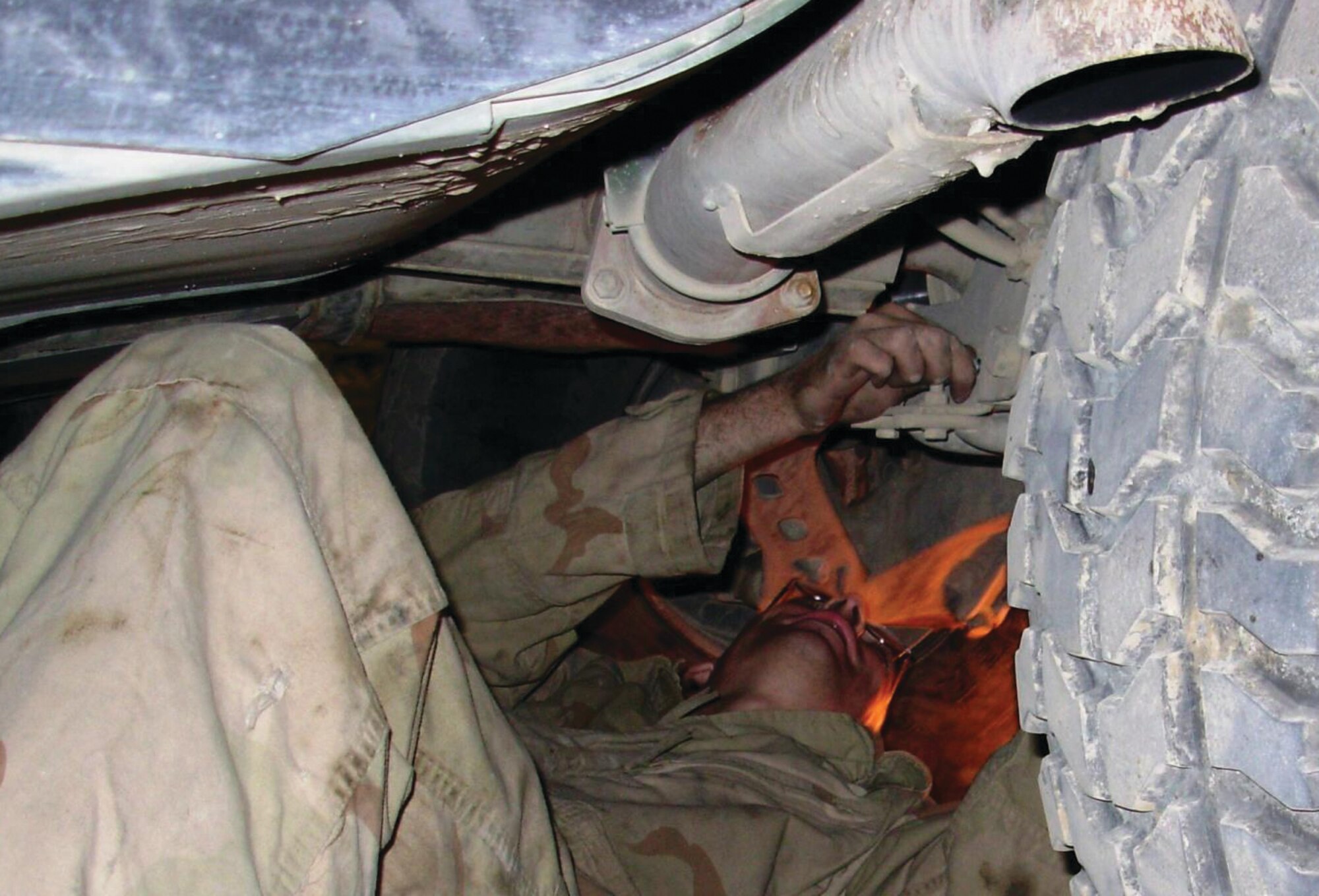 Amn Michael E. Moore, 90th Logistics Readiness Squadron Vehicle Mechanic deployed Sather Air Base in Baghad repairs an Army up-armored HMMWV used by a unit at another base.  The unit performs an Army mission by patrolling Baghdad neighborhoods.  Their vehicles were starting to show the extreme wear and tear of the difficult and dangerous mission, so they turned to the Airman Moore's unit for help.  The team returned nine HMMWVs to service, allowing the Security Forces to field complete patrol teams in serviceable vehicles.