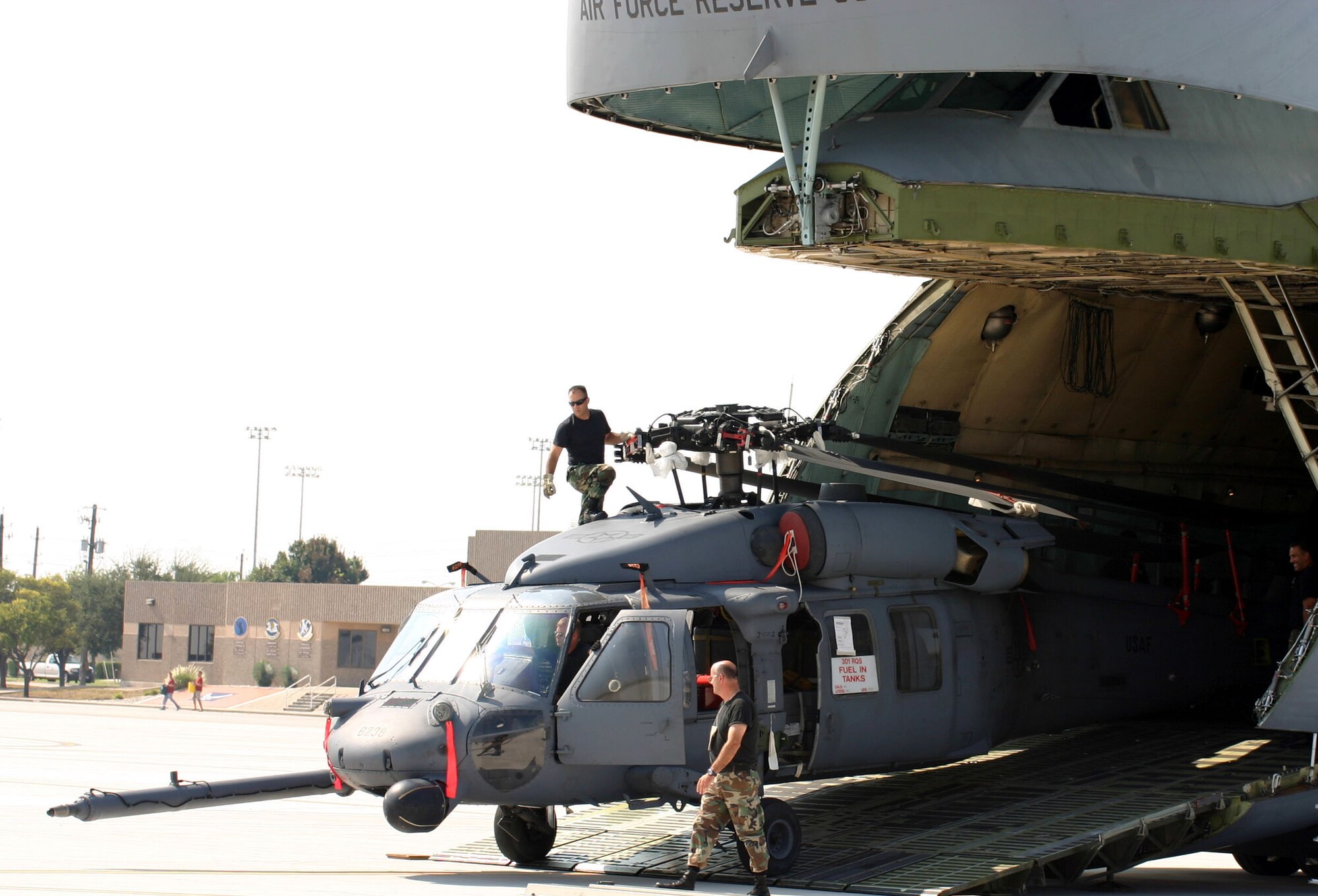 LAUGHLIN AIR FORCE BASE, Texas (AETCNS) -- Members of the 920th Rescue Wing from Patrick Air Force Base, Fla., unload one of three HH-60 Pave Hawk helicopters at Laughlin AFB, Texas. A C-5 Galaxy crew from Westover Air Reserve Base, Mass., delivered members of the search and rescue wing to Laughlin to pre-position the helicopters in response to Hurricane Rita, which is expected to hit landfall this weekend. Two additional Pave Hawks from Davis-Monthan Air Force Base, Ariz., flew to Laughlin Sept. 22 to support hurricane relief efforts. (U.S. Air Force photo by Master Sgt. Anthony Hill)