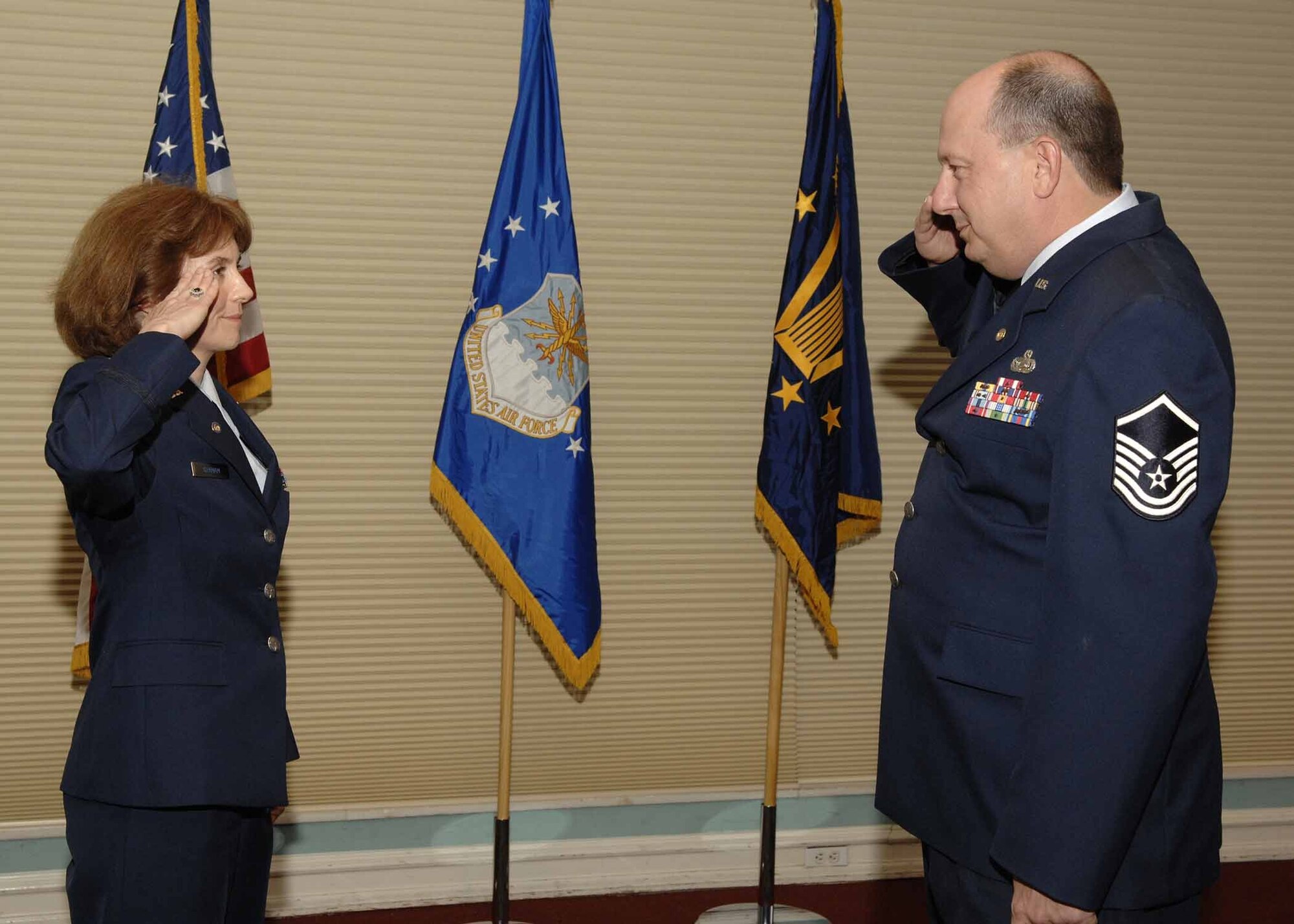 EGLIN AIR FORCE BASE, Fla.— At her retirement ceremony Oct. 5, Maj. Alicia Graham reserved her last salute for retired Master Sgt. Jack Pio, who returned the traditional silver dollar she had given him in 1986 to commemorate her first salute. (Photo by Craig McDonnell)

