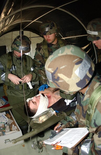 From left to right: Capt. Aaron Ament, 5th Medical Operations Squadron, Senior
Airman David Engler, 5th MDOS, Senior Airman Ryan Woodson, 5th Medical Support Squadron and Staff Sgt. Felicia Young, 5th MDOS (holding clipboard), attend to Airman 1st Class Wesley Stallard, 5th Communications Squadron, during the 5th Medical Group’s medical unit readiness training exercise Oct. 5. (Photo by Airman Sharida Bishop)