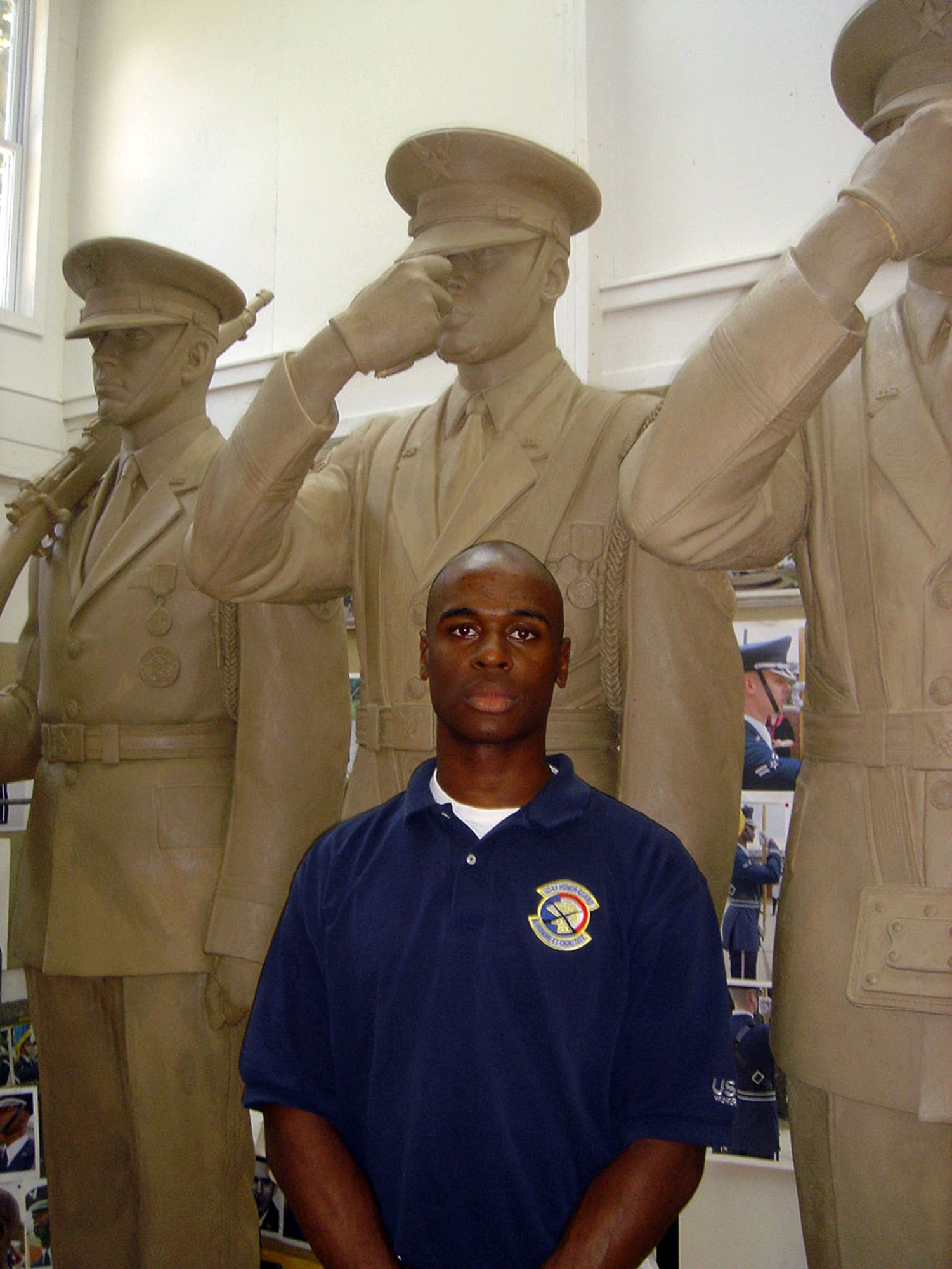 Senior Airman Michael Goodwin stands in front of the Air Force Honor Guard statue while still in production in July 2005.  Airman Goodwin was used as a model for one of the bronze sculptures now residing at the Air Force Memorial. (U.S. Air Force photo)                                                                                      