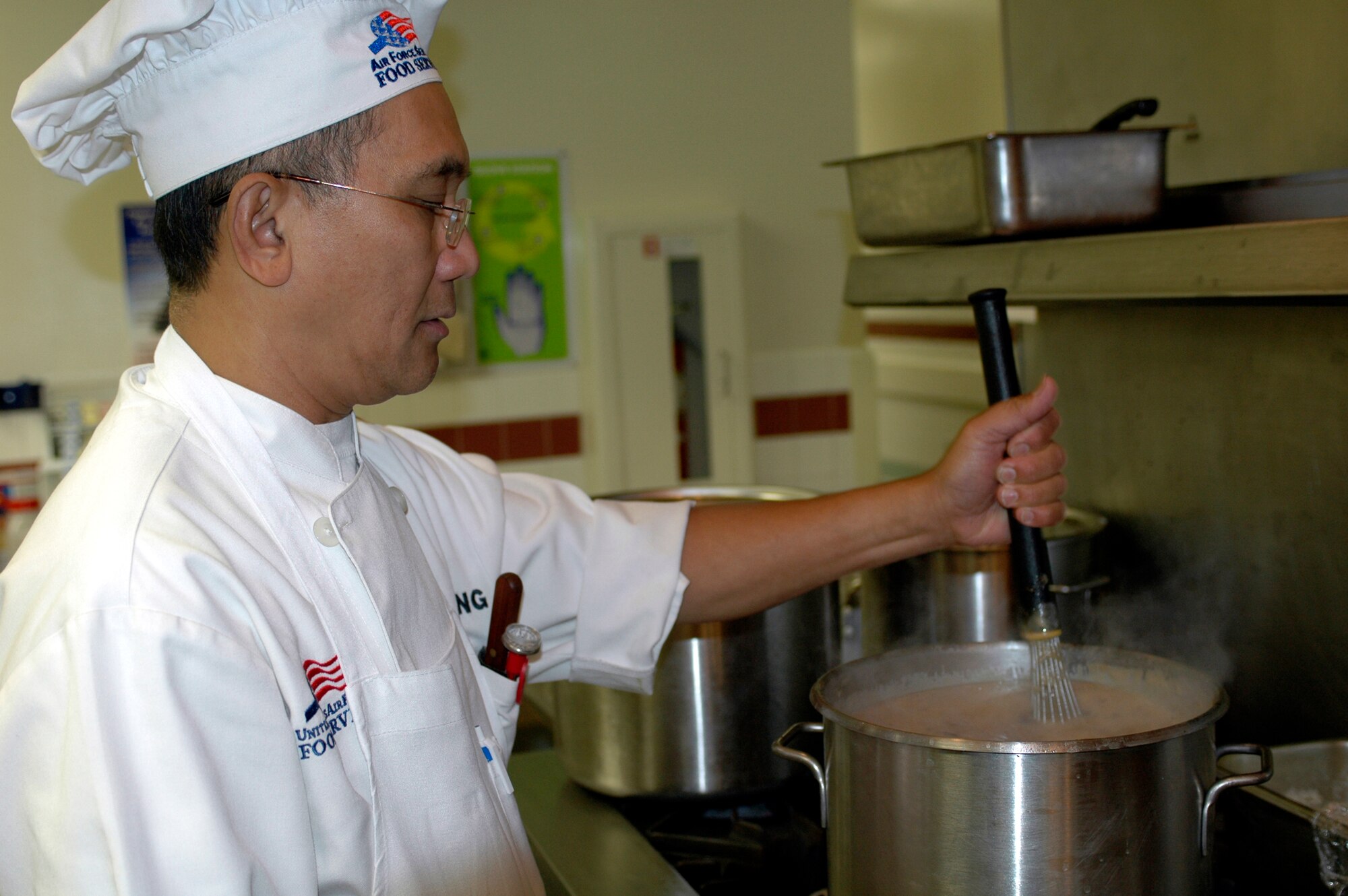 Mr. Victor Batesting, 60th Services Squadron cook, stirs the “soup of the day.” As a result of customer surveys and suggestions, the Food Service team implemented several programs, including weekly ethnic meals an a internet café, to increase overall customer satisfaction. (U.S. Air Force photo by Staff Sgt. Candy Knight/60th AMW Public Affairs)
