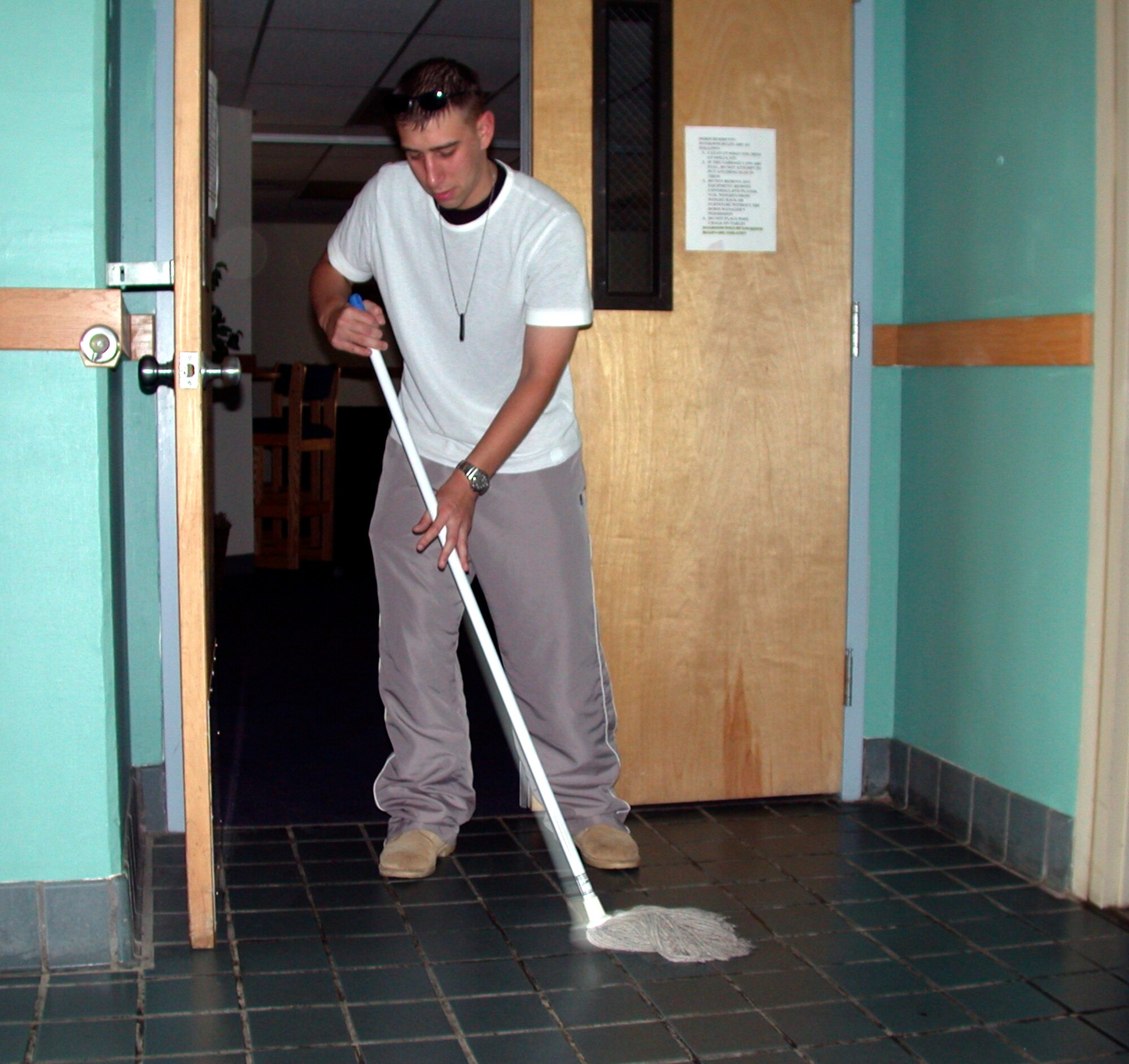 Airman Jeffrey Keyes, Surgical Service Apprentice student, mops the entry way to his dorm's common area during the 60th Medical Group’s Dormitory Pride Day, Oct. 7. Airmen assigned to the 60th Medical Group’s Aerospace Medical Service, Surgical Service, Medical Laboratory, Diagnostic Imaging, Diagnostic Ultrasound and Cardiopulmonary Phase II Apprentice programs spent the weekend cleaning all areas of their dormitory. (U.S. Air Force photo by Tech Sgt Austin Delacruz, Jr./60th Medical Operations Squadron)