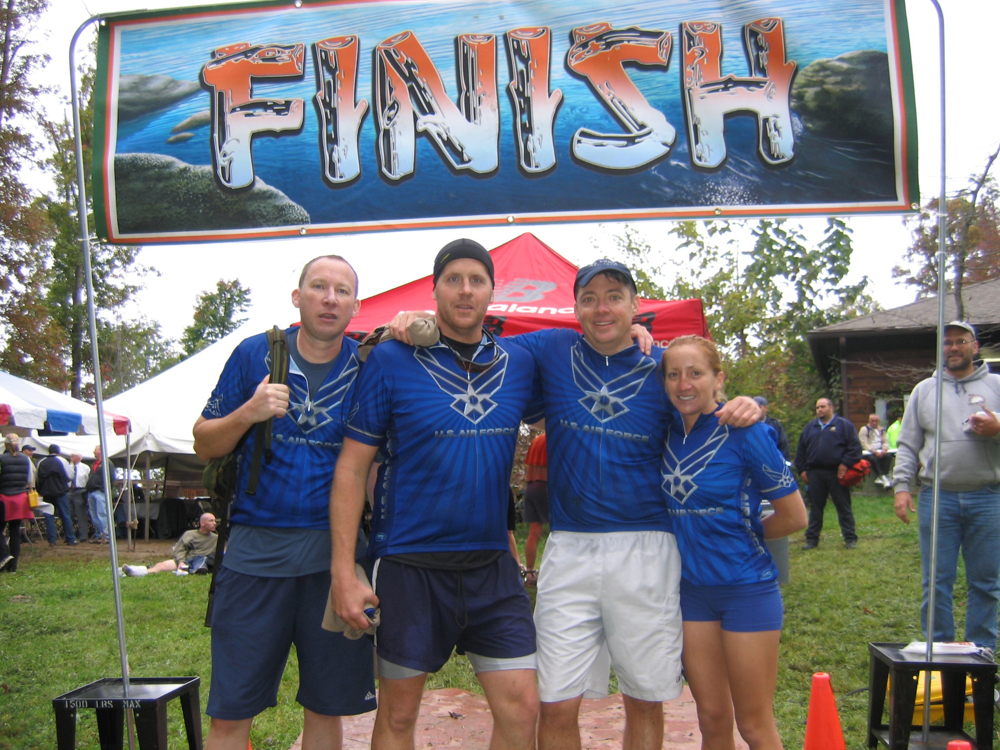 Gene Vesey, Dick Fulton, Mike Sonderman and Randi Miles, members of the DFASt Wilderness Challenge team, pose at the finish line Oct. 7 after the two-day, 53-mile 6-event military adventure race. Vesey, Fulton and Sonderman are part of the Defense Finance Accounting Service crew, while Miles is a member of the 460th Comptroller Squadron. They placed first out of the five Air Force teams and 16th out of the 51 teams that competed.