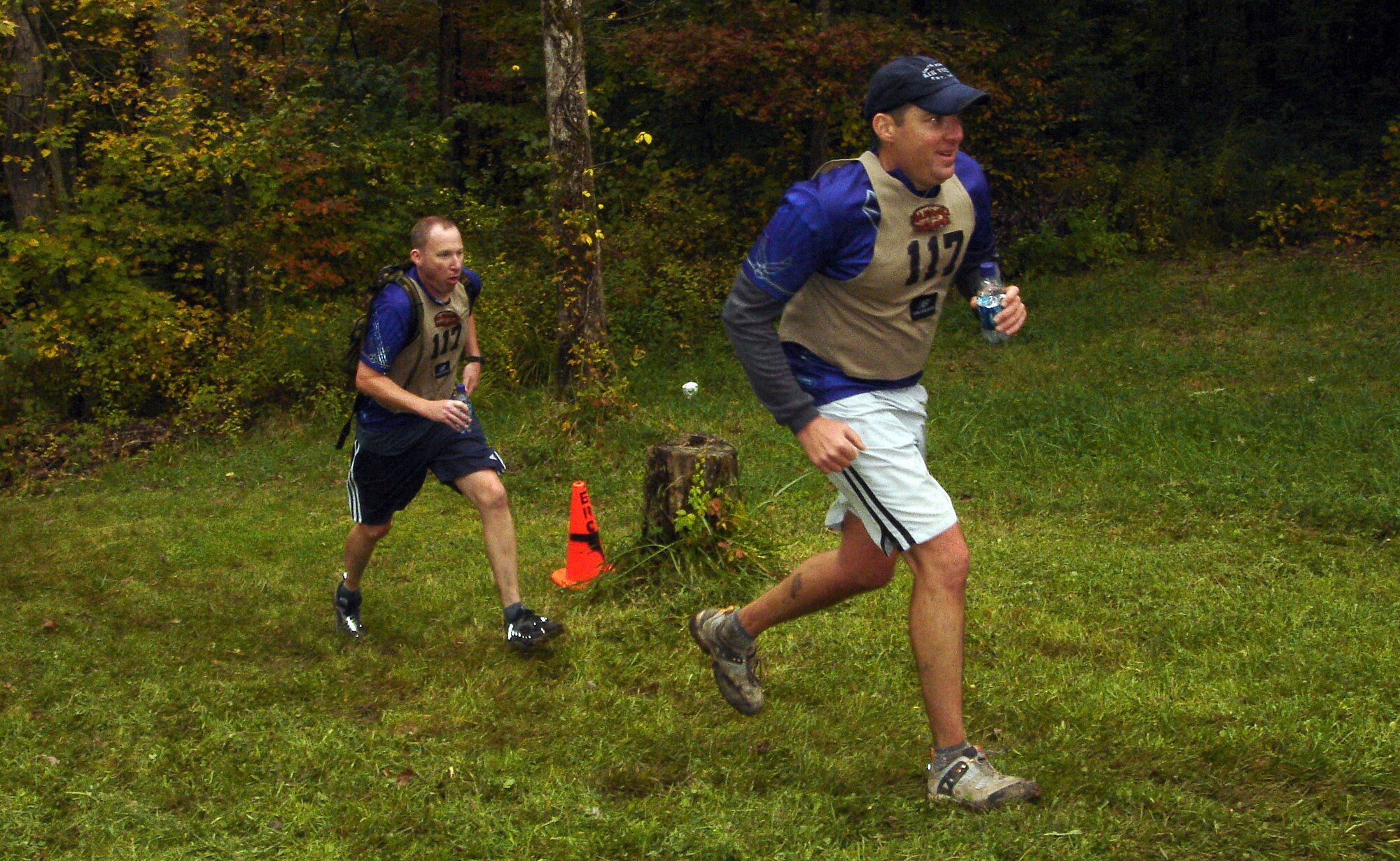 Mike Sonderman and Gene Vesey, members of the Defense Finance Accounting Service and 460th Comptroller Squadron Wilderness Challenge team, DFASt, run the last 200 yards of the 53-mile, six-event military adventure race Oct. 7. DFASt came in first out of five Air Force teams and 16th out of all 51 teams.                 