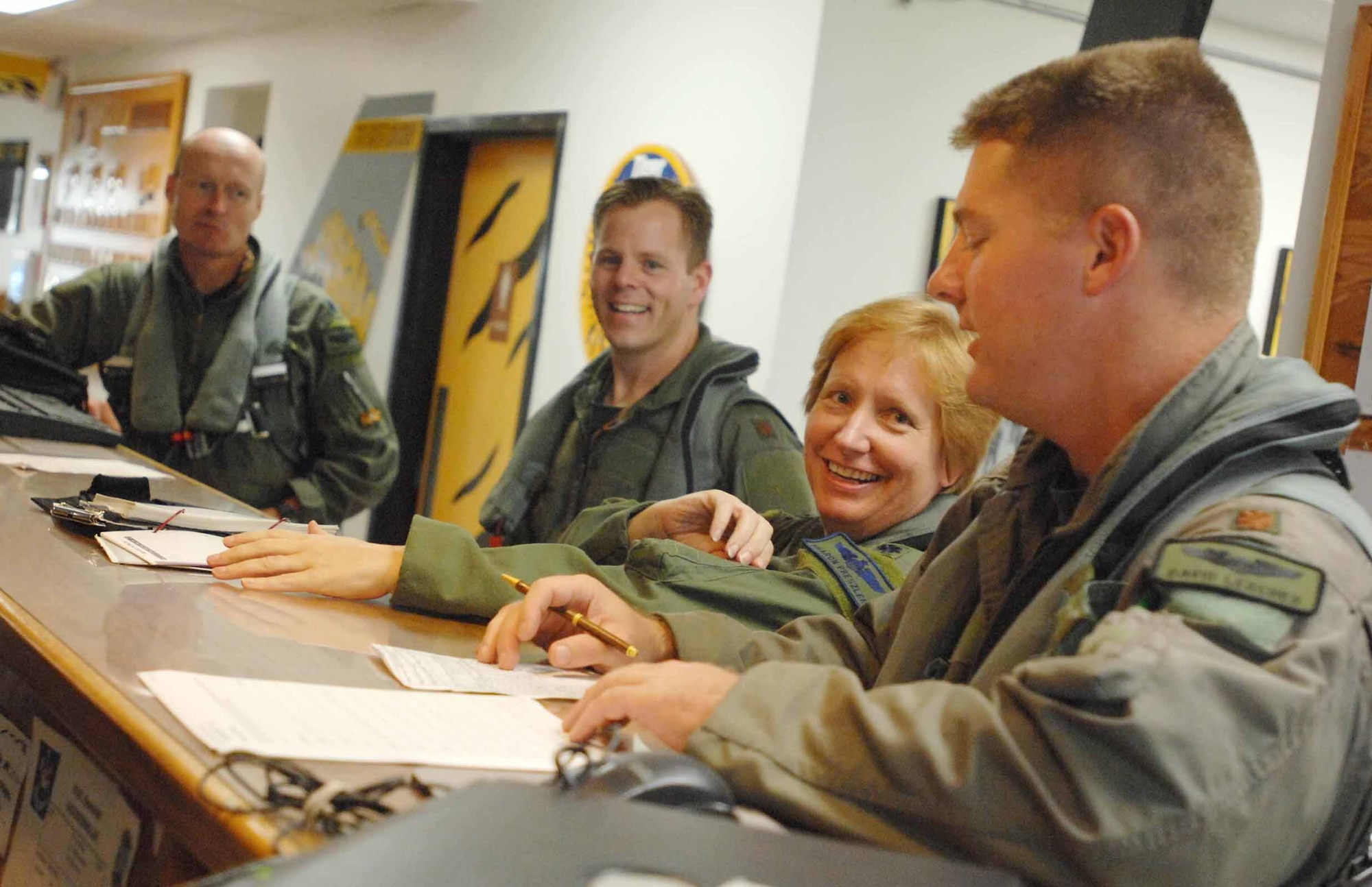 Lt. Col. Sharon Preszler, 20th Fighter Wing staff director and Commander's Action Group director, shares a few words with her fellow fighter pilots Thursday in the 79th Fighter Squadron prior to her fini flight. (U.S. Air Force photo/Staff Sgt. Josef Cole III)