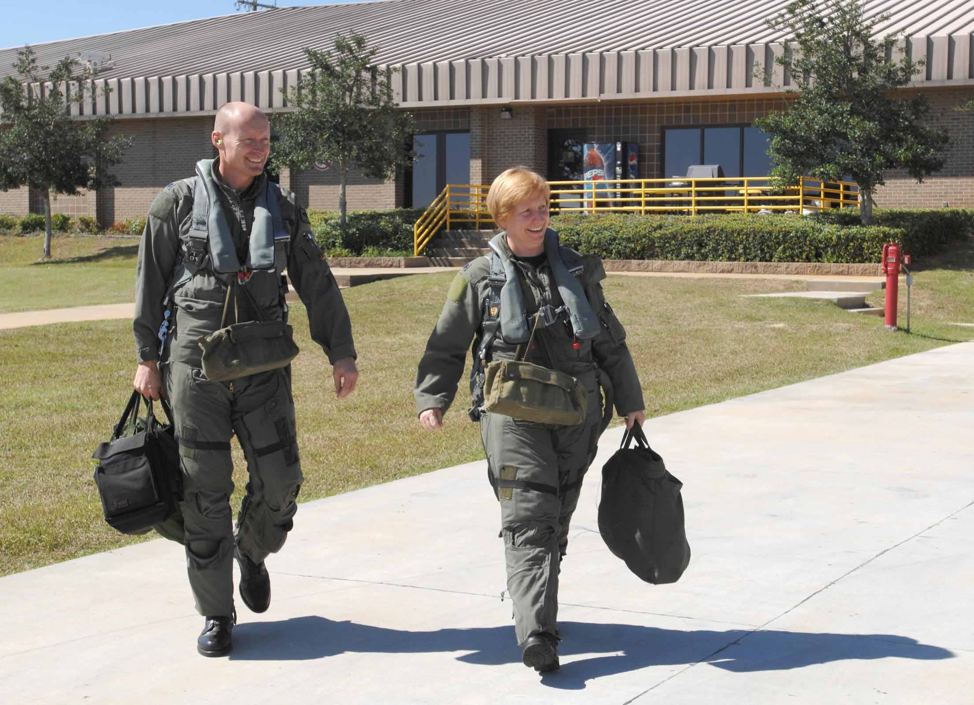 Lt. Col. Sharon Preszler, 20th Fighter Wing staff director and Commander's Action Group director, and Lt. Col. Scott Manning, 79th Fighter Squadron commander, walk out to their jets Thursday for Col. Prezsler's fini flight. (U.S. Air Force photo/Staff Sgt. Josef Cole III)