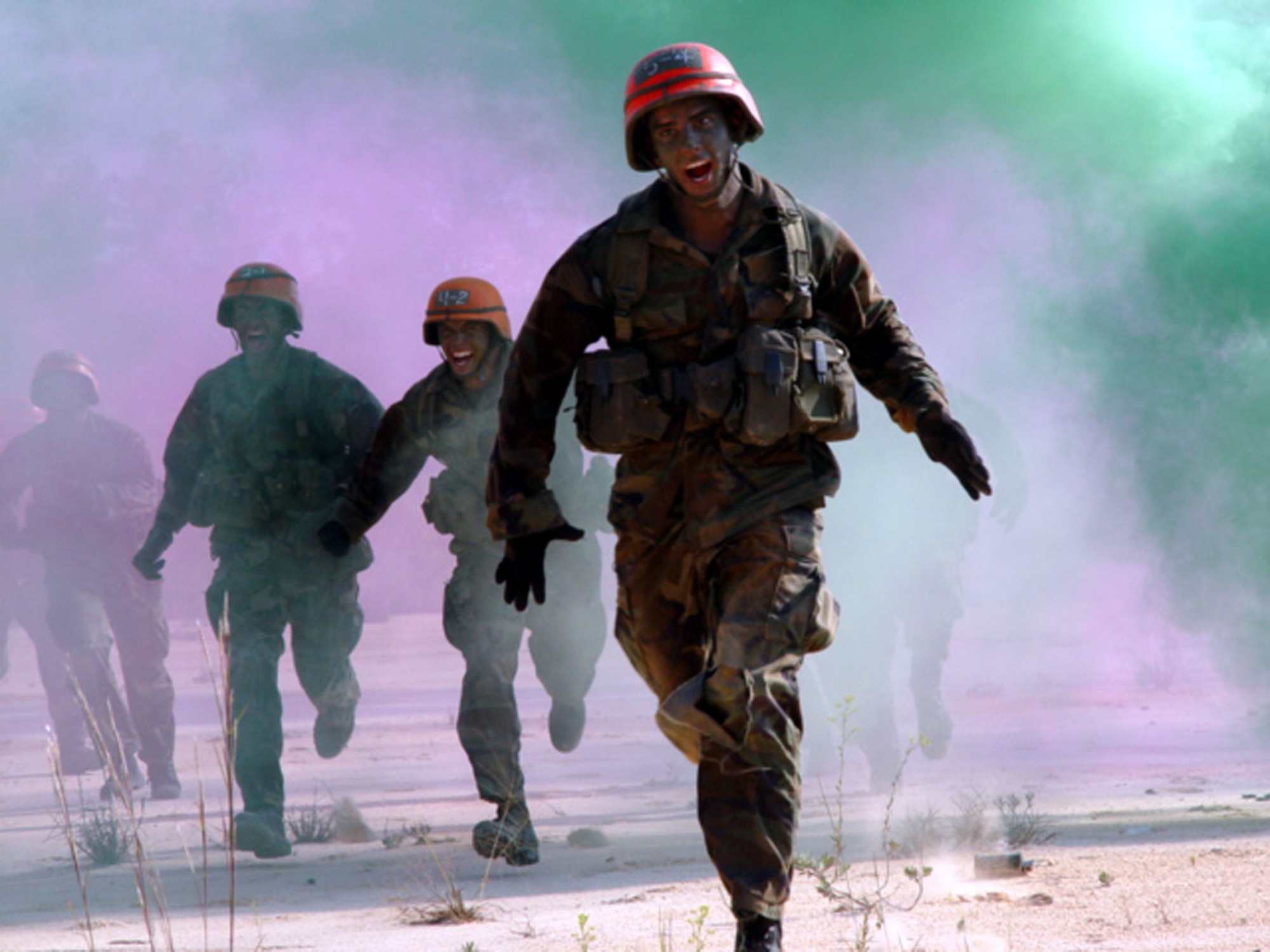 Tactical Air Control Party  students rush through smoke as they move onto small unit tactics training. (U.S. Air Force Photograph by Technical Sgt. Brian Murray)