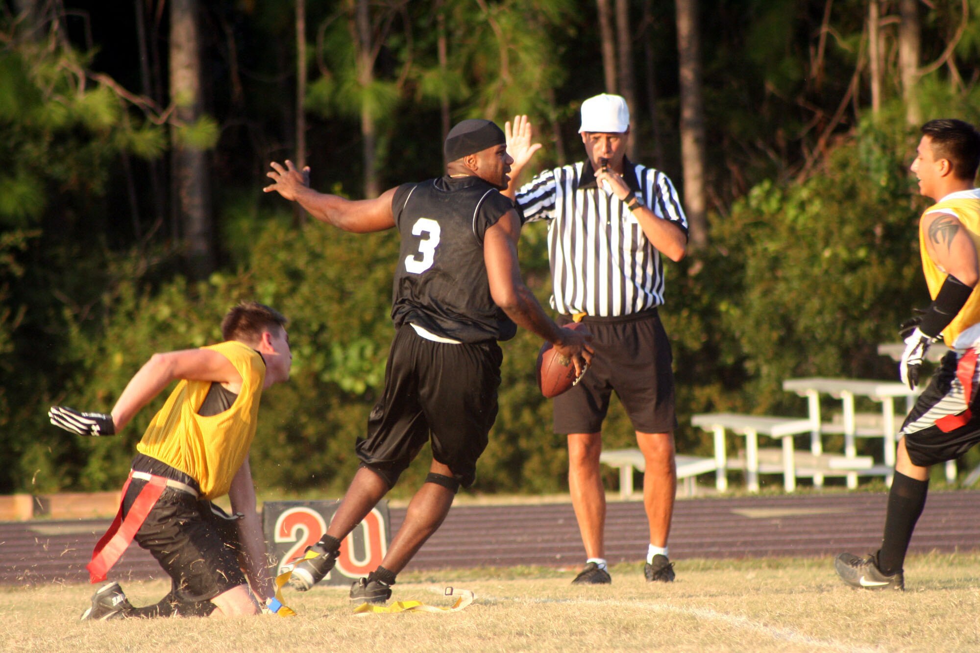 A 16th Helicopter Maintenance Squadron intramural flag football team player strips the flag of an Air Force Special Operations Forces Regional Supply Squadron team player here Oct. 10. (U.S. Air Force Photograph by Staff Sgt. Kelly Ogden)