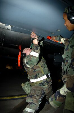 Staff Sergeant Duncan Tripp and Senior Airman Camile Davis, 4th Equipment Maintenance Squadron, perform routine maintenance on a F-15E Strike Eagle during a Phase II Exercise October 4, 2006. The exercise is one of many in preparation for an   Operational Readiness Inspection in January of 2007 that will test the base's war readiness. (U.S. Air Force photo by A1C Greg Biondo)