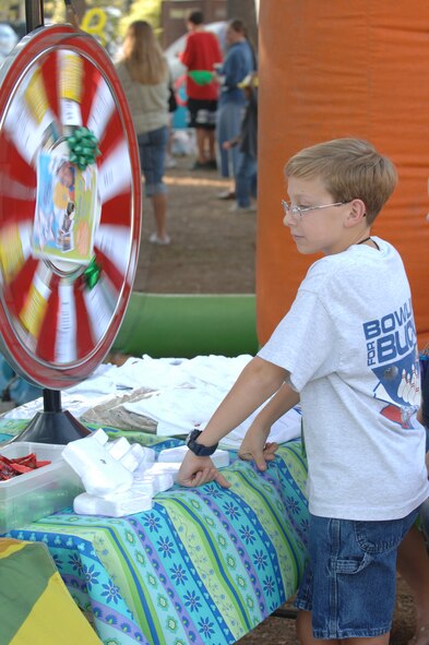 Jacob Leuquire spins a wheel for a prize during Octoberfest. (U.S. Air Force photo by Airman Nathan Lipscomb)