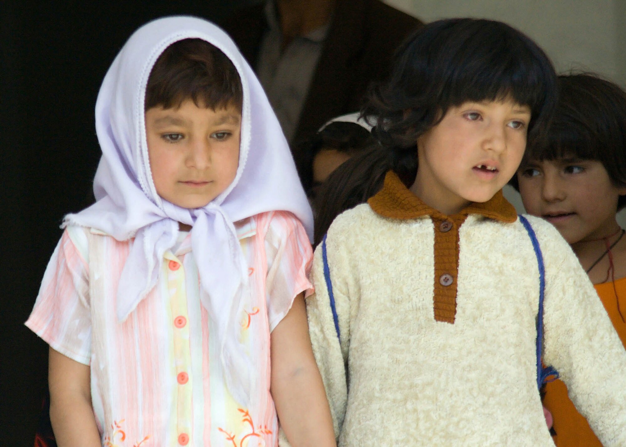 PANJSHIR PROVINCE, Afghanistan -- Students from the Dashtak School file down the steps into the schoolyard before the dedication of the school's new well October 10. Panjshir Director of Education Riza Rizai opened the ceremony with thanks to the Panjshir Provincial Reconstruction Team for their assistance in making the well a reality for a school that did not have a well previously. Rizai spoke of the importance of education for boys and girls. The Dashtak School is coed, a rarity in Afghanistan. The Panjshir PRT project was funded by the Commander's Emergency Response Program. The students sang the Afghanistan national anthem and other traditional songs. (Photos by Air Force Tech. Sgt. John Cumper).
